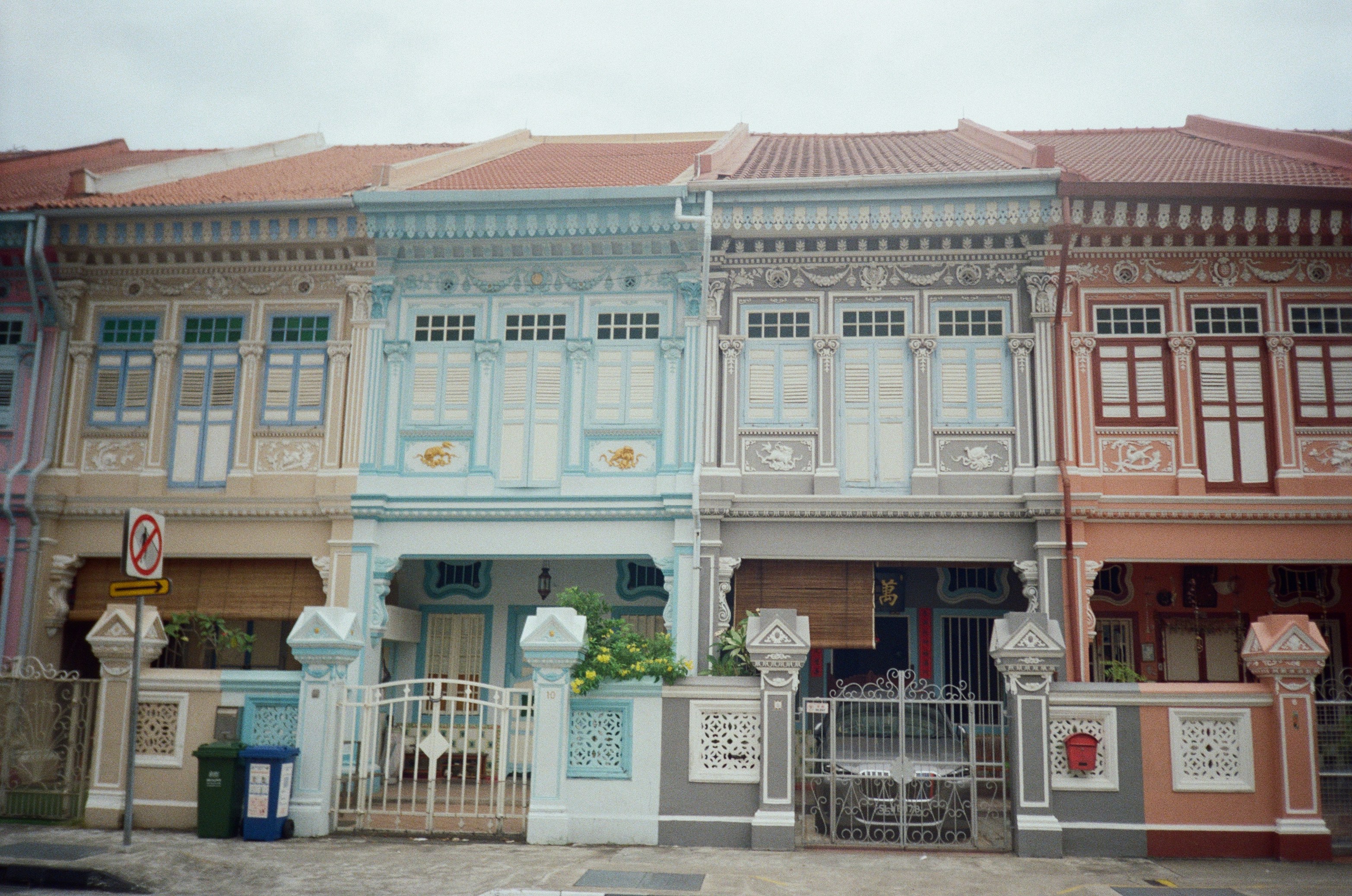 Row of colorful traditional shophouses with ornate facades