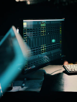 A computer monitor displays control software in a dark room