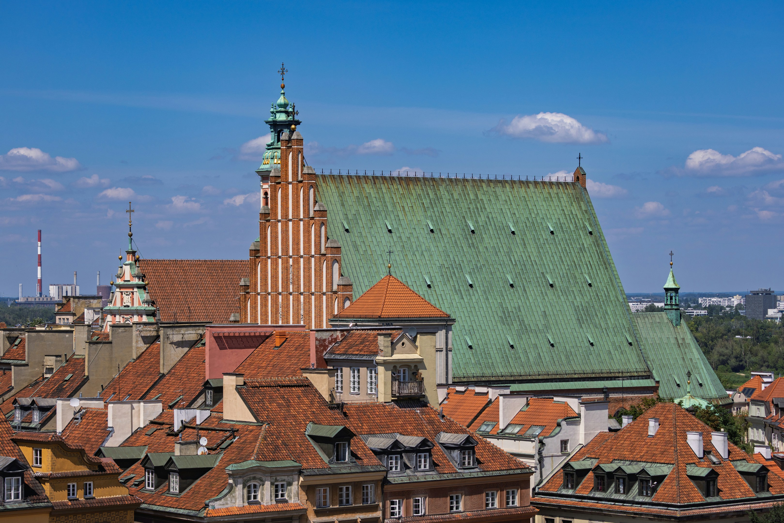 Historic church with green roof dominates an old city skyline