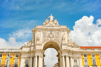 Majestic arco da rua augusta in lisbon under blue sky.