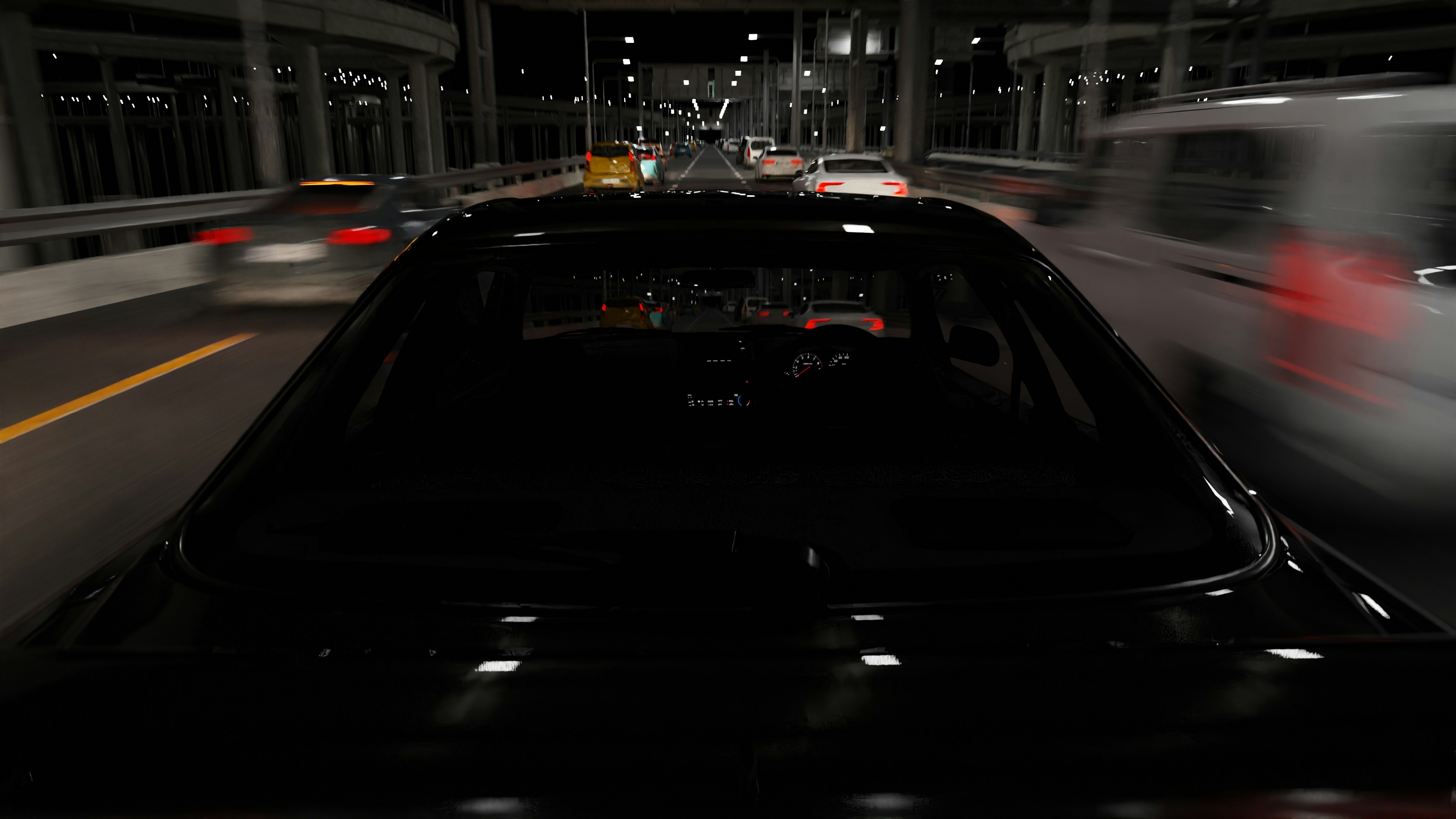 A black car driving on a busy highway at night