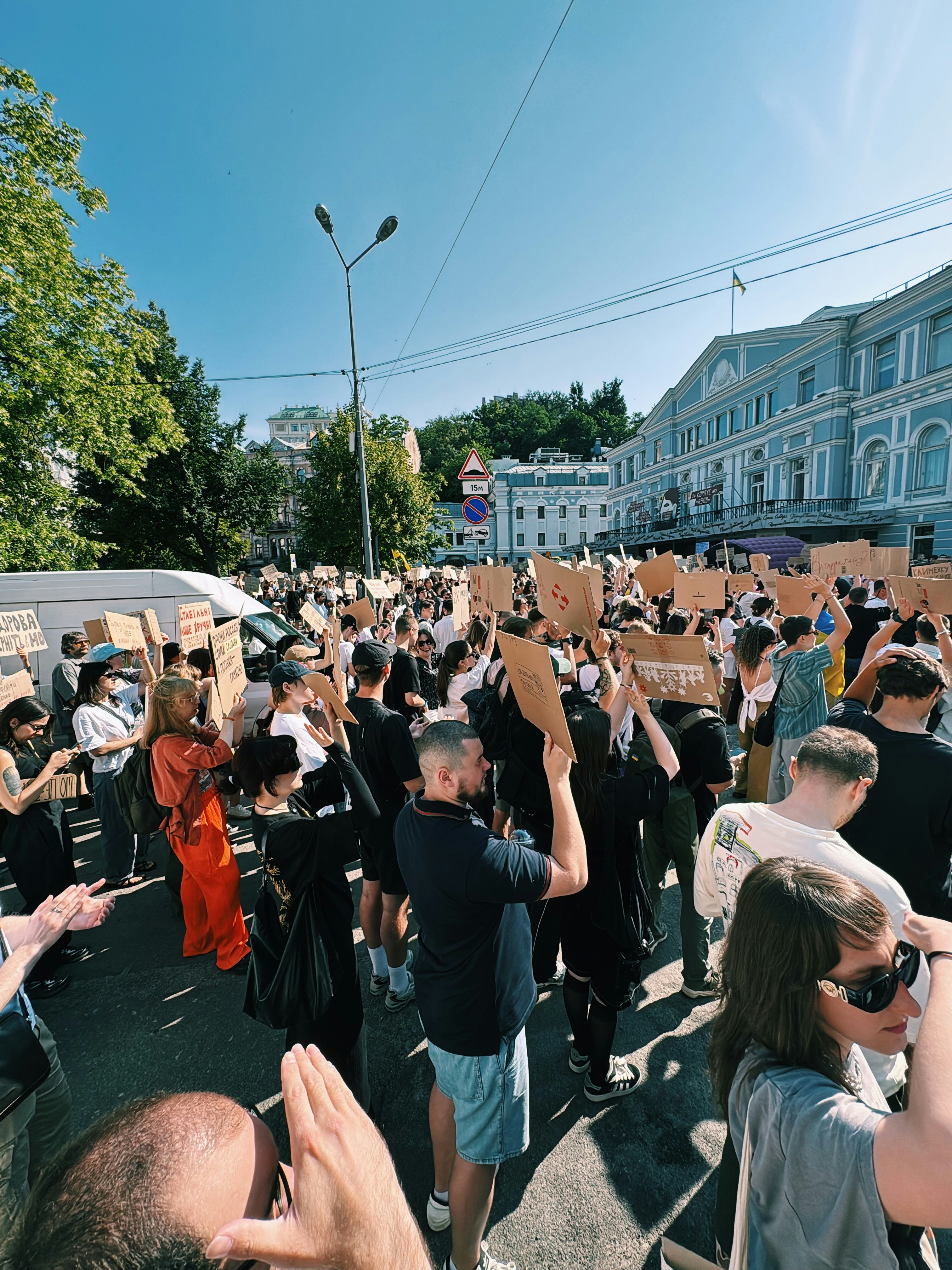 A large crowd of people protesting with signs outdoors.