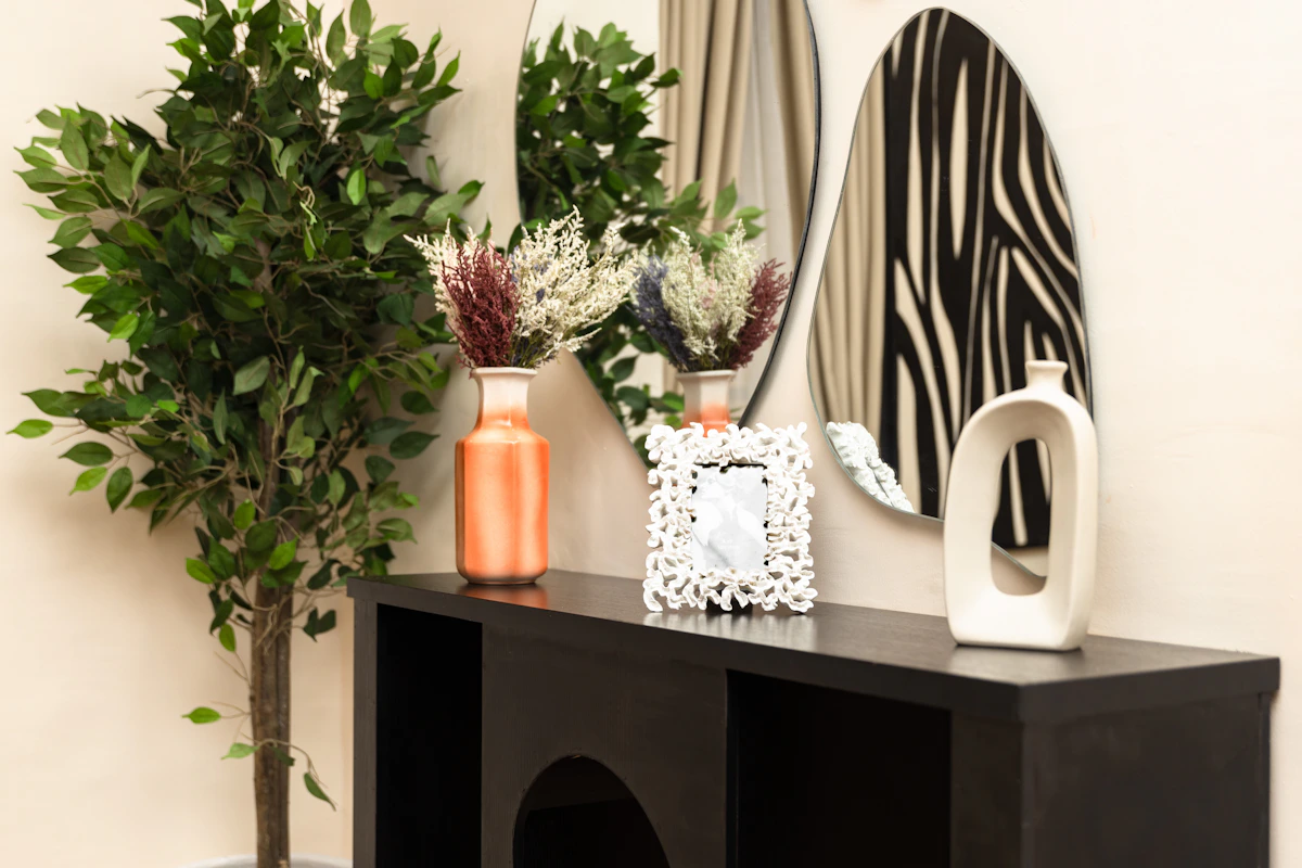 Console table styled with vases, shelving and decorative mirrors