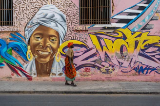 A person walks past a vibrant street art mural