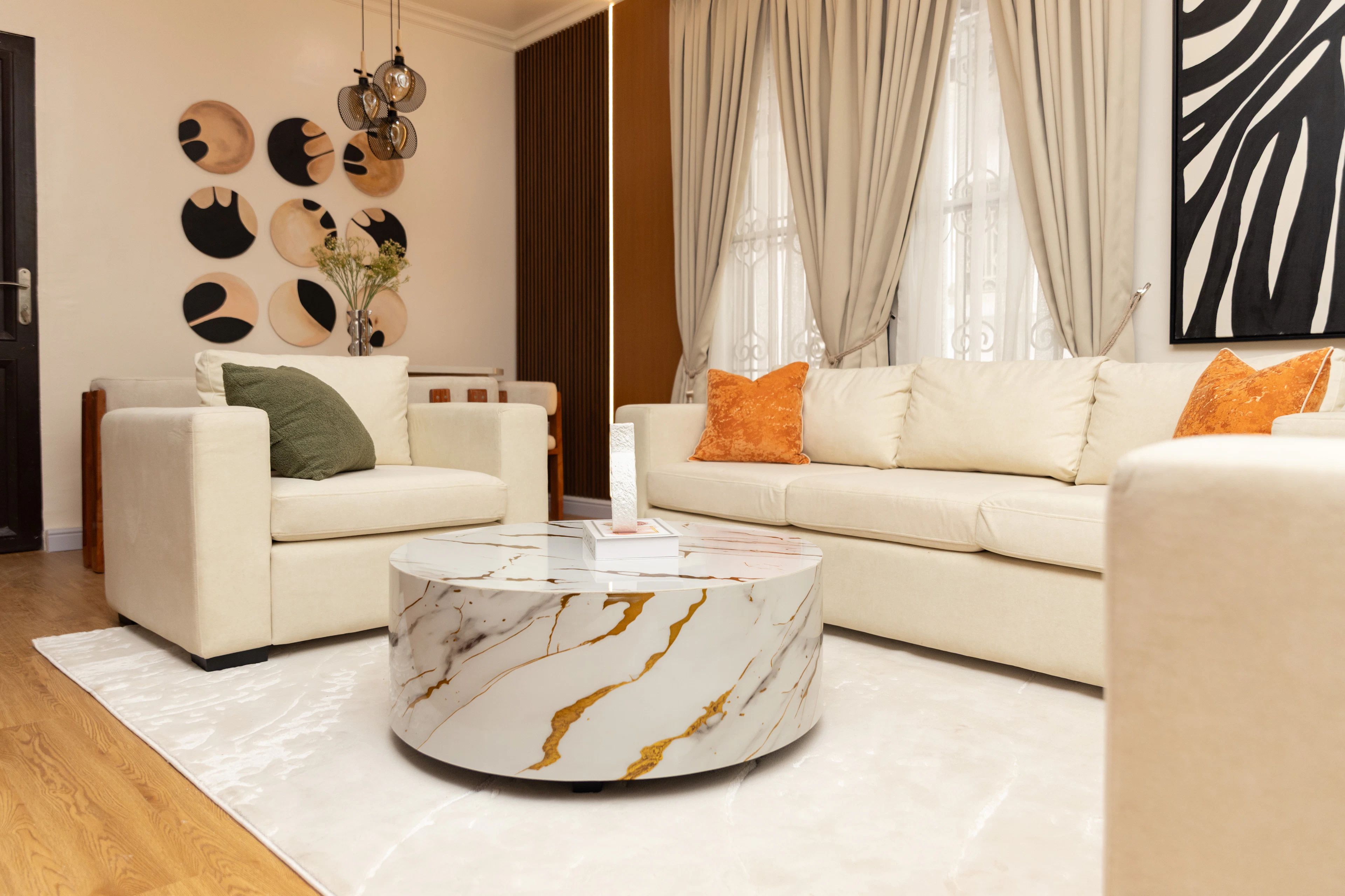 Living room with designer sofas and a marble coffee table