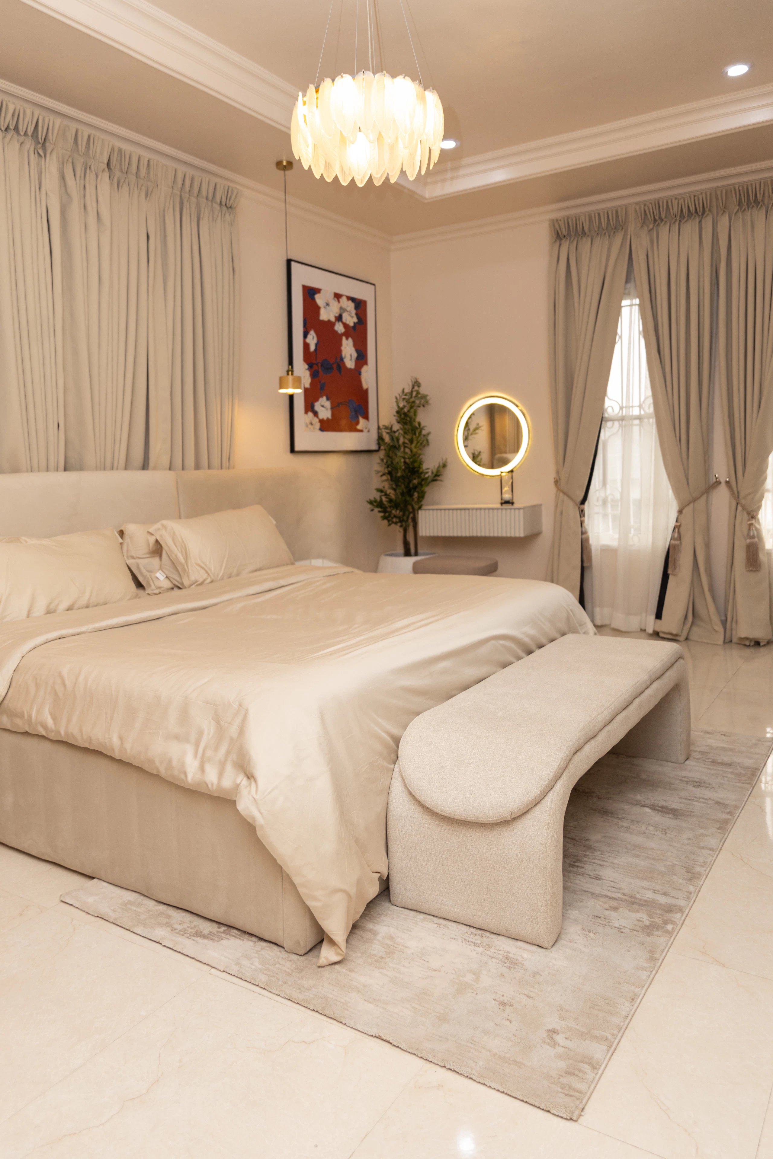 Bedroom with bench and statement chandelier