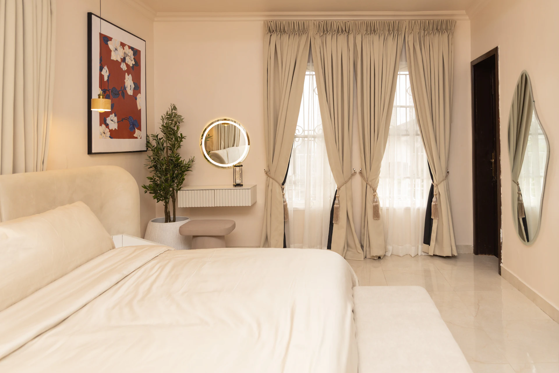 Bedroom in a Dubai apartment with heavy floor-to-ceiling curtains drawn across a large window