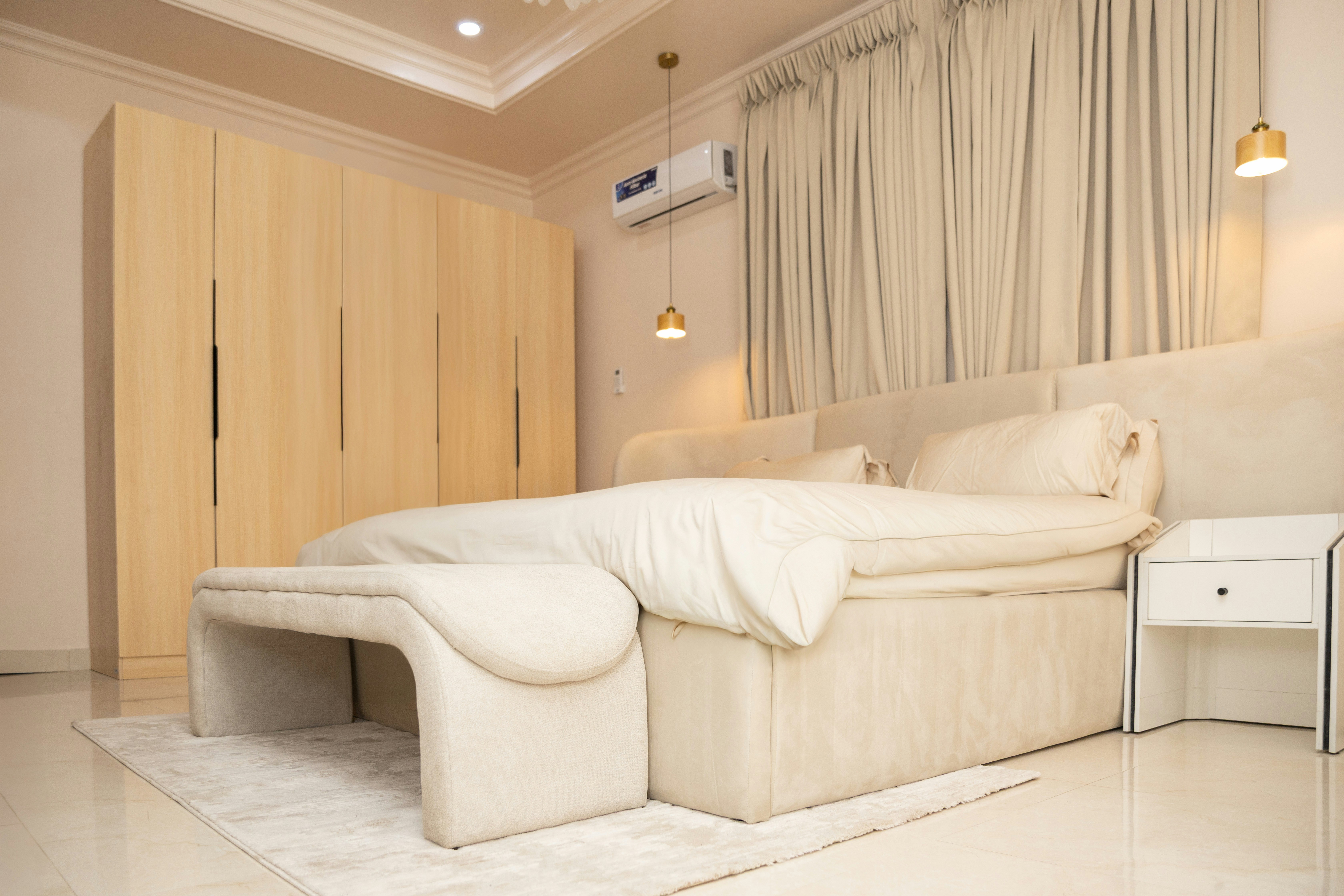 Elegant bedroom featuring a large bed and built-in wardrobes