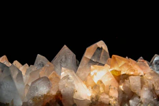 Sharp, glowing quartz crystals against a dark background