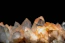 Sharp, glowing quartz crystals against a dark background