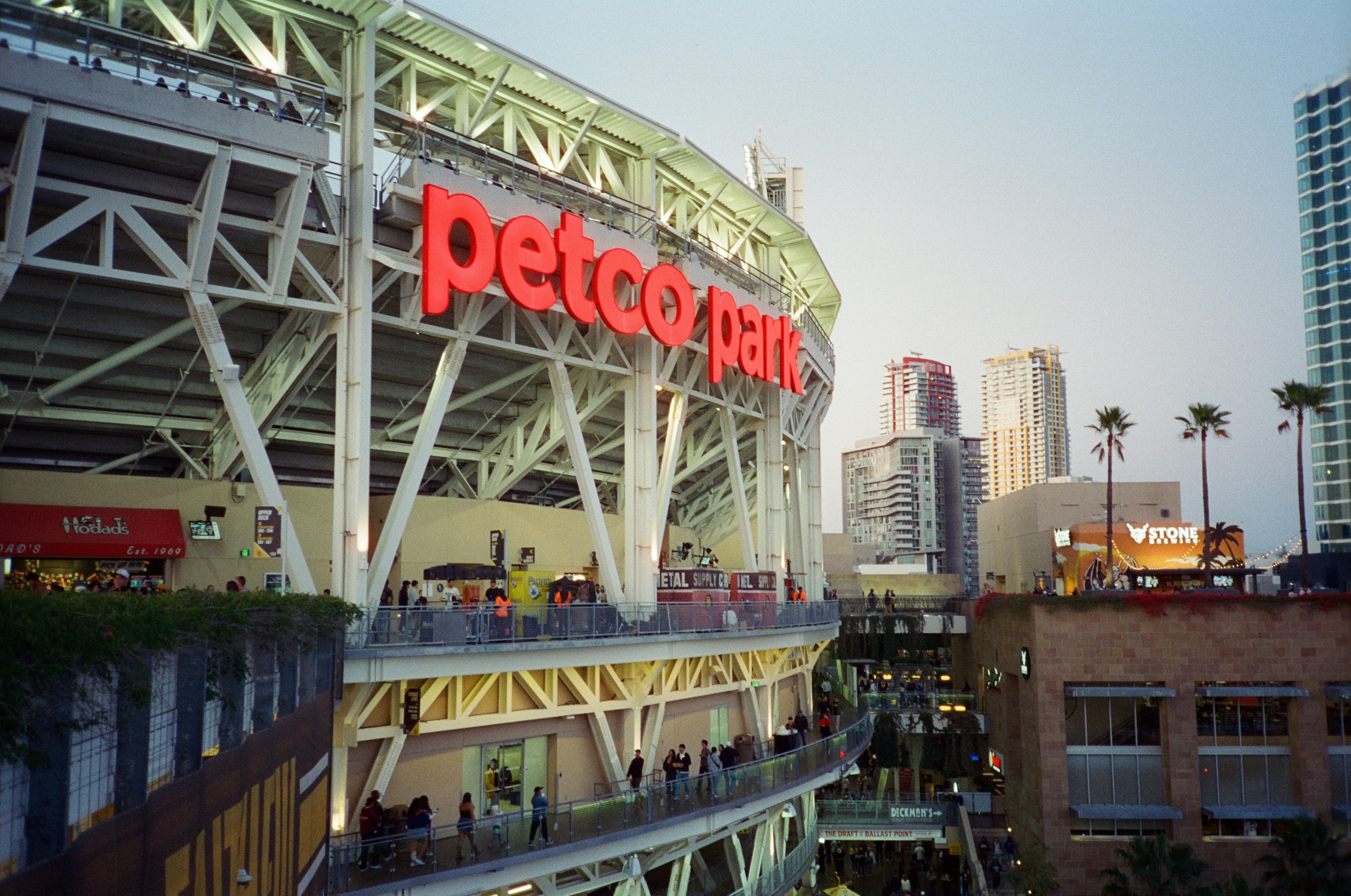 Petco park stadium at dusk with downtown buildings