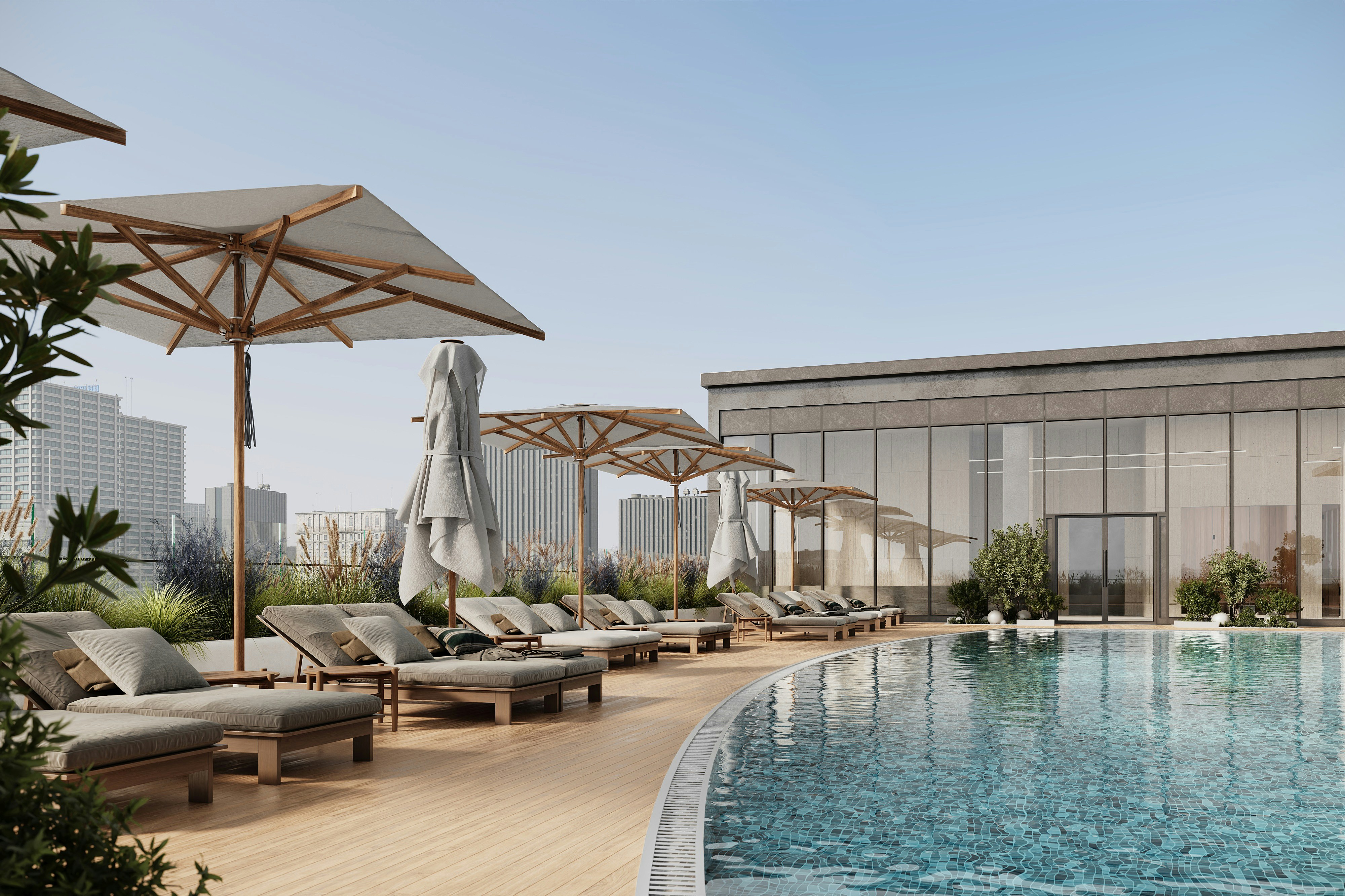 Modern outdoor swimming pool with lounge chairs and city views.
