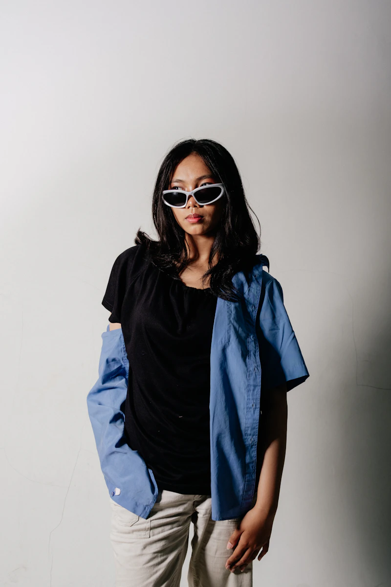 Front-facing portrait of a person in a denim shirt