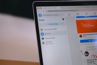 A laptop screen displays the facebook interface showing pages.