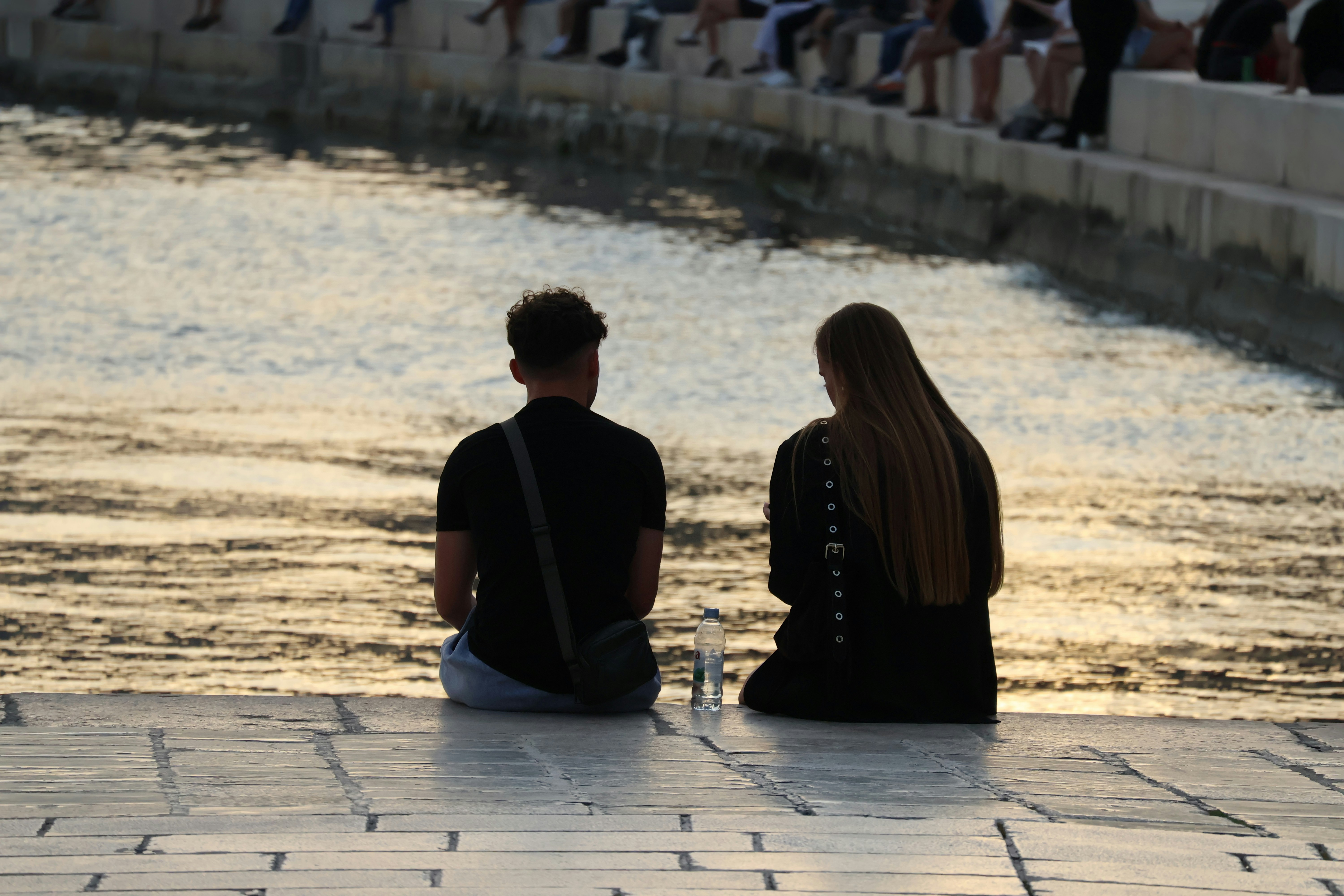 Couple sitting apart and thinking about emotional distance and loss of sexual desire in their relationship