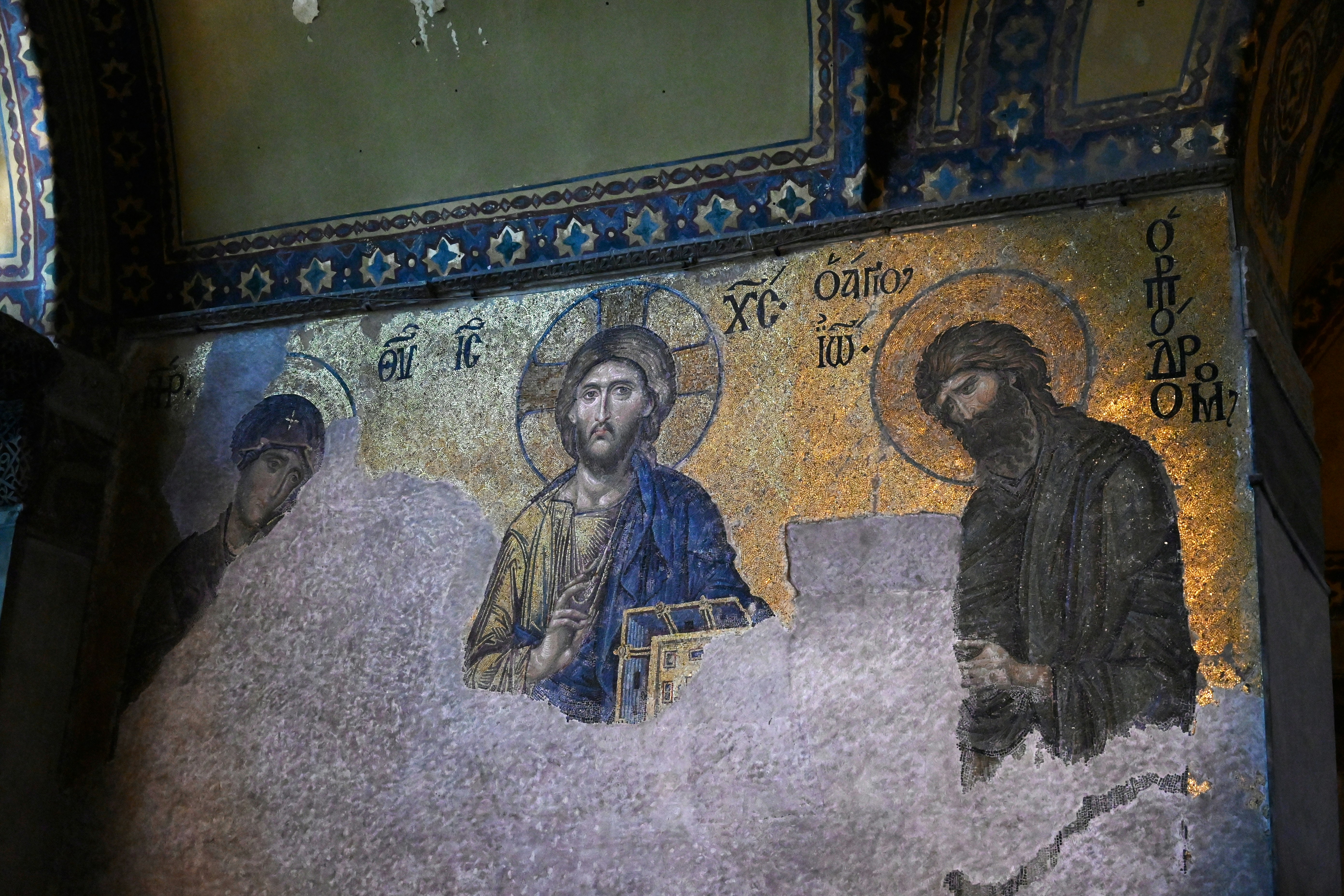 Ancient, damaged mosaic of jesus christ and two figures