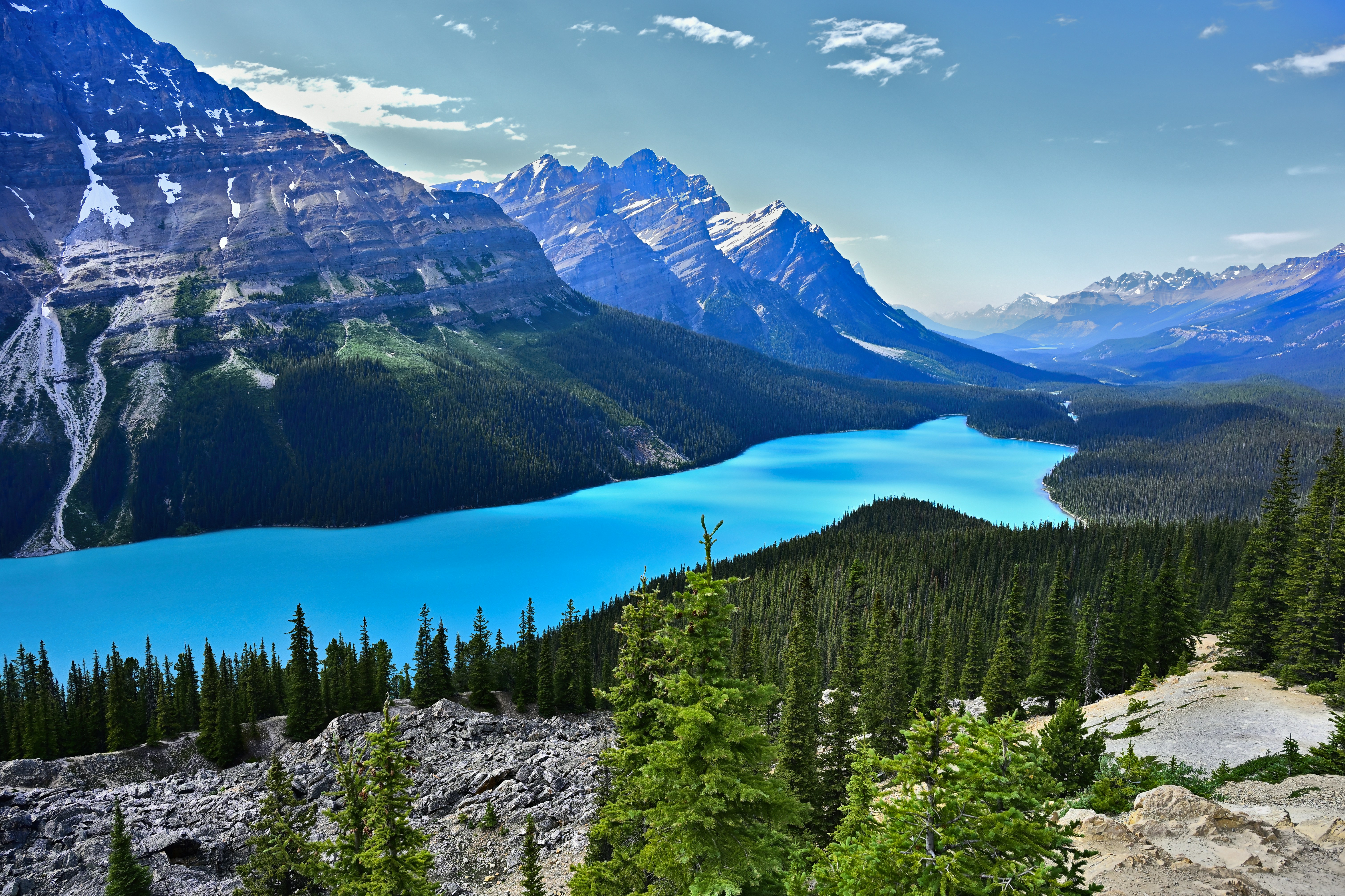 Stunning turquoise lake nestled among majestic mountains and green forests