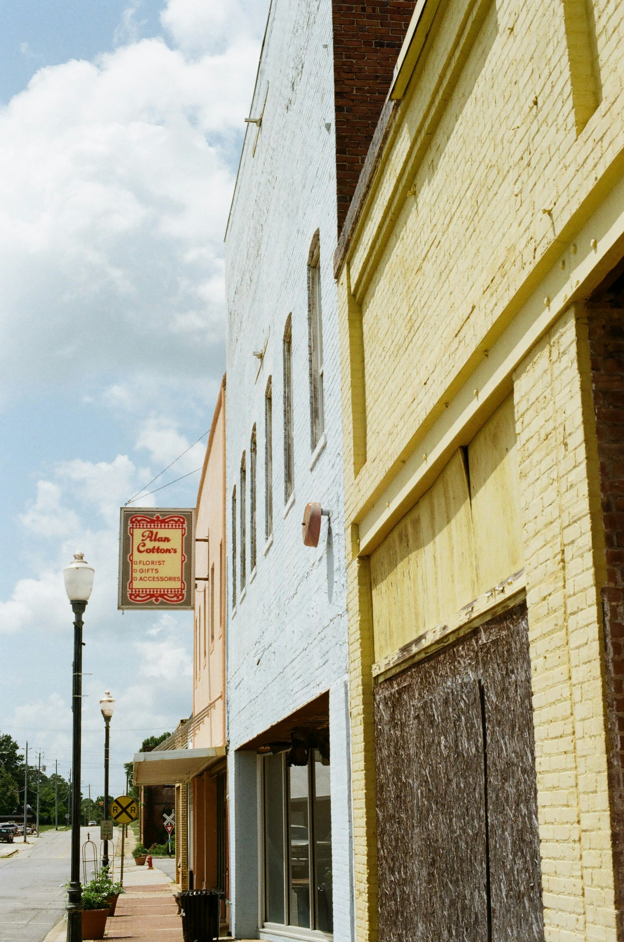 Quaint streetscape featuring colorful old buildings and an antique sign.