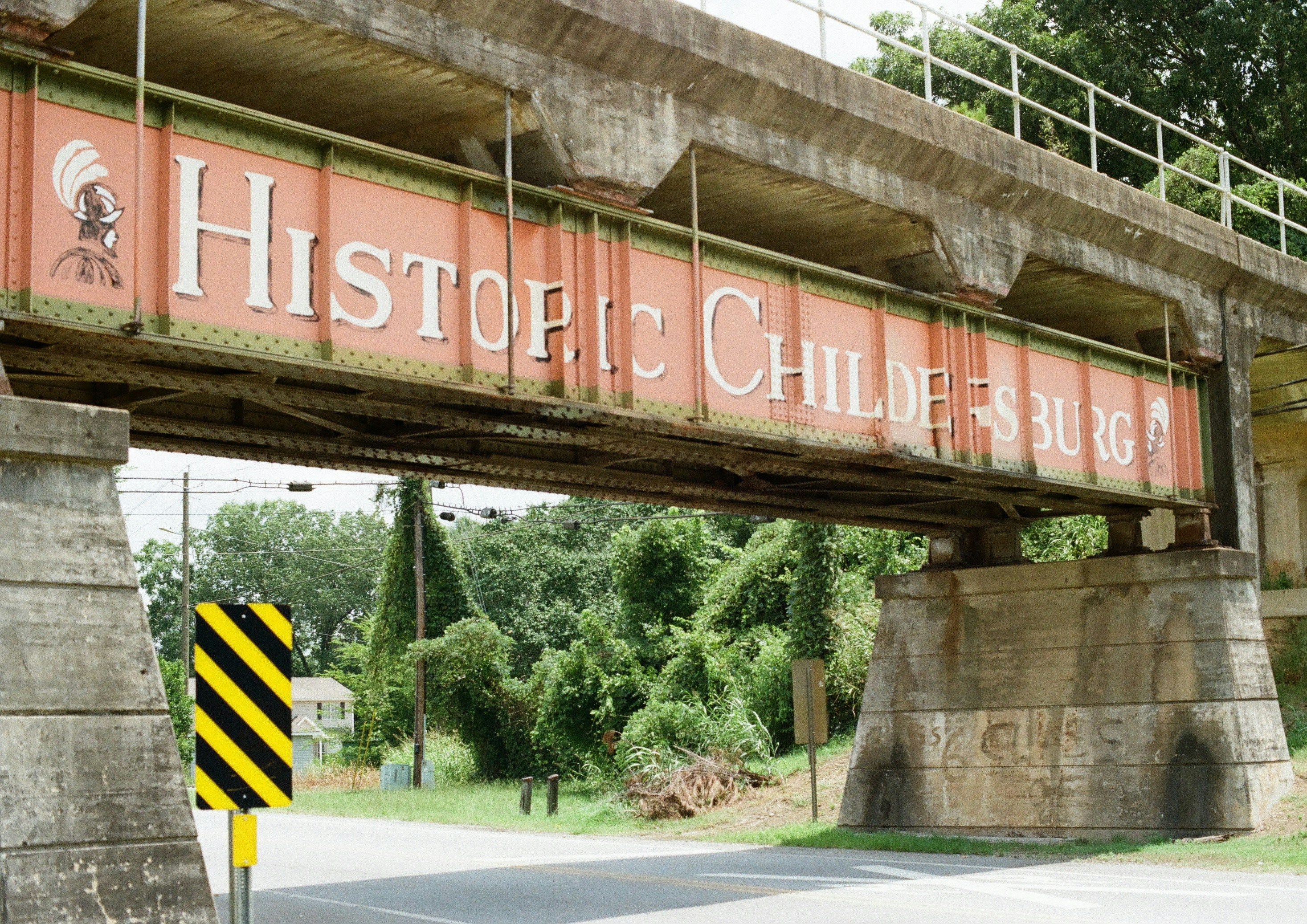 Historic childersburg sign on a concrete and metal bridge.