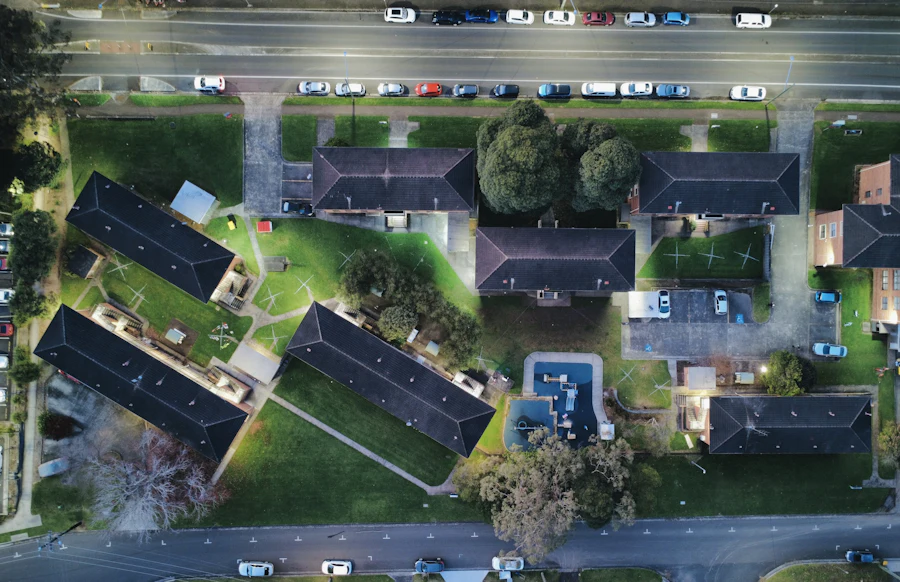 Aerial view of residential streets and buildings lit at night.