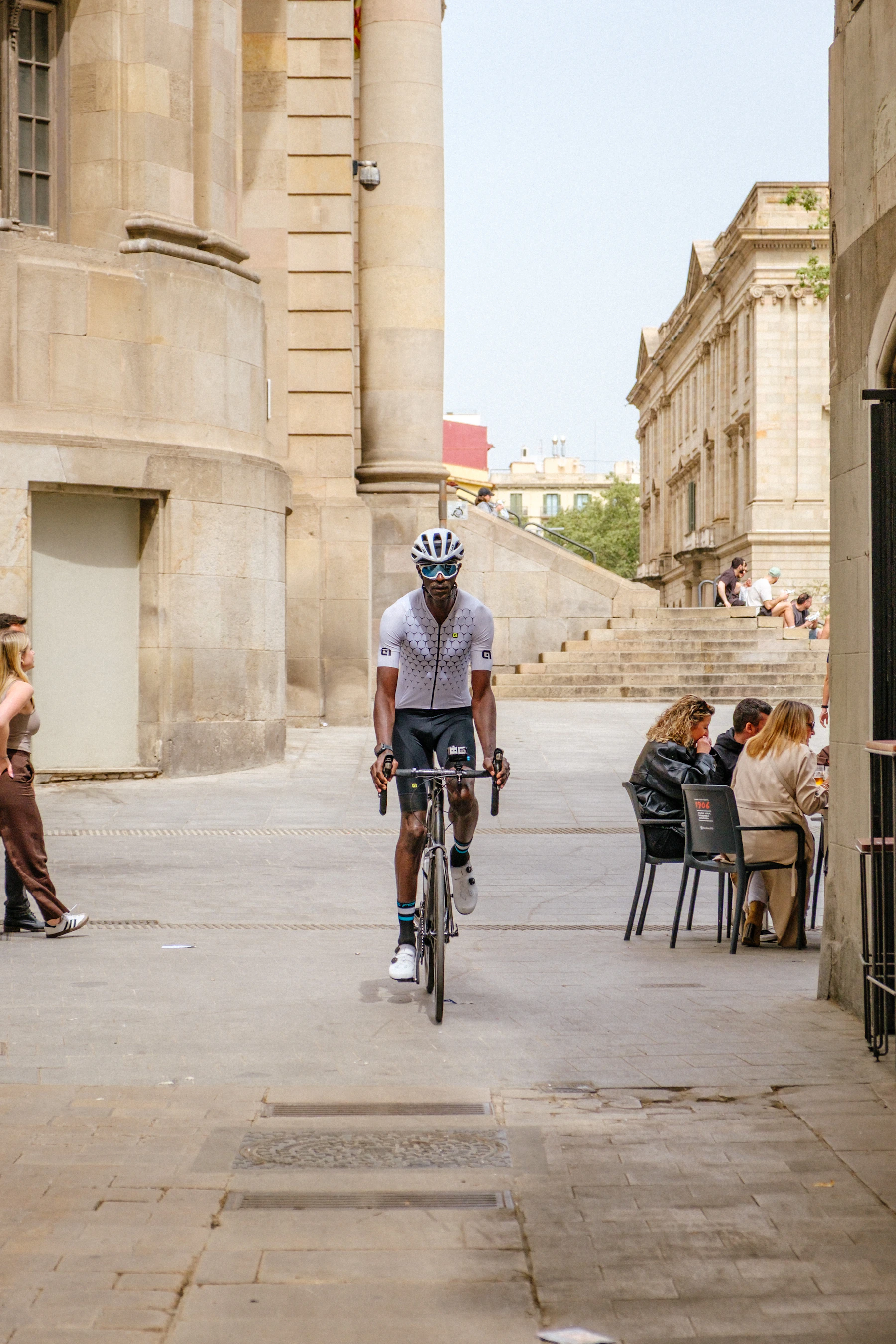 Cyclist riding through an urban street with practical cycling equipment