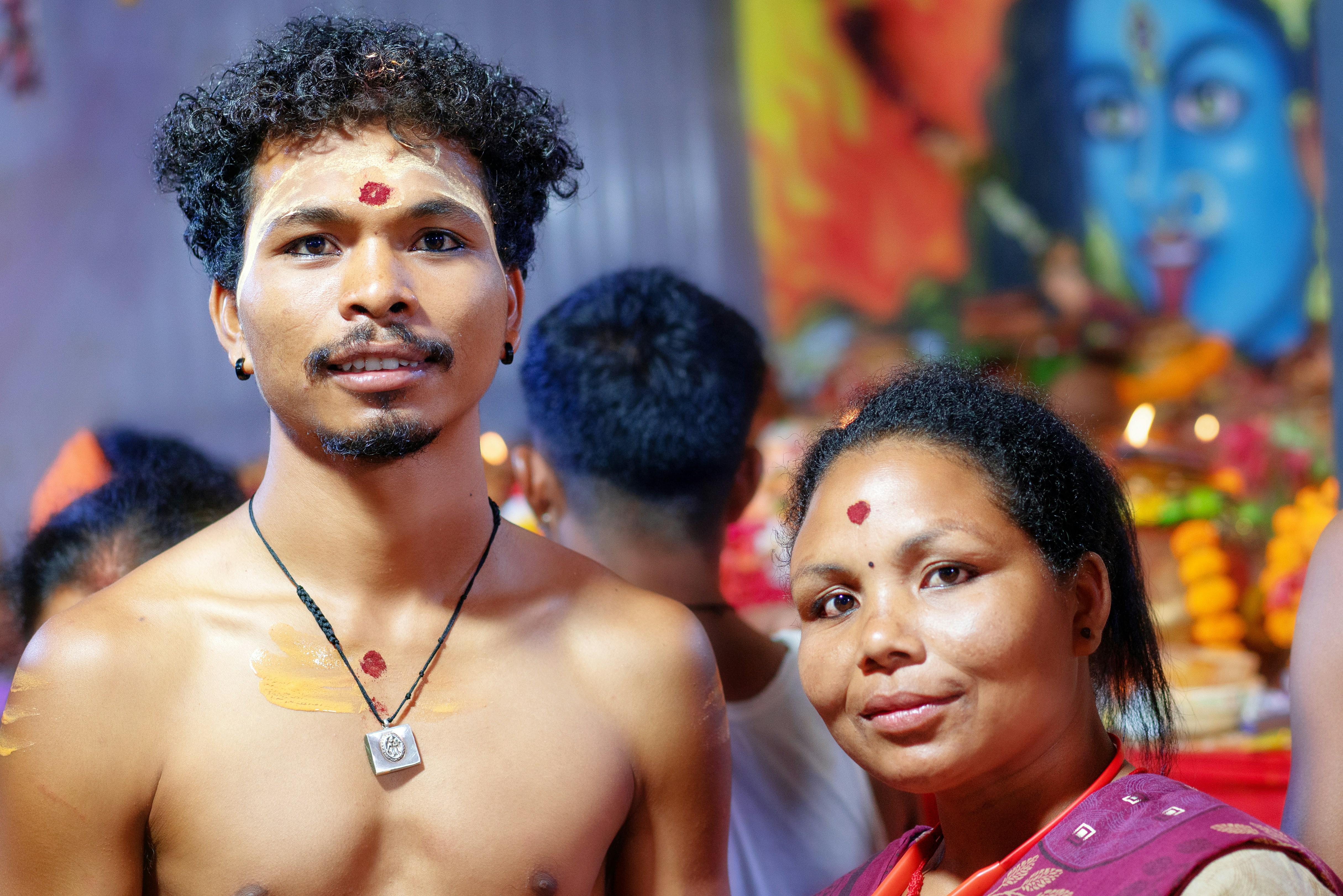 Man and woman with bindis at a religious gathering