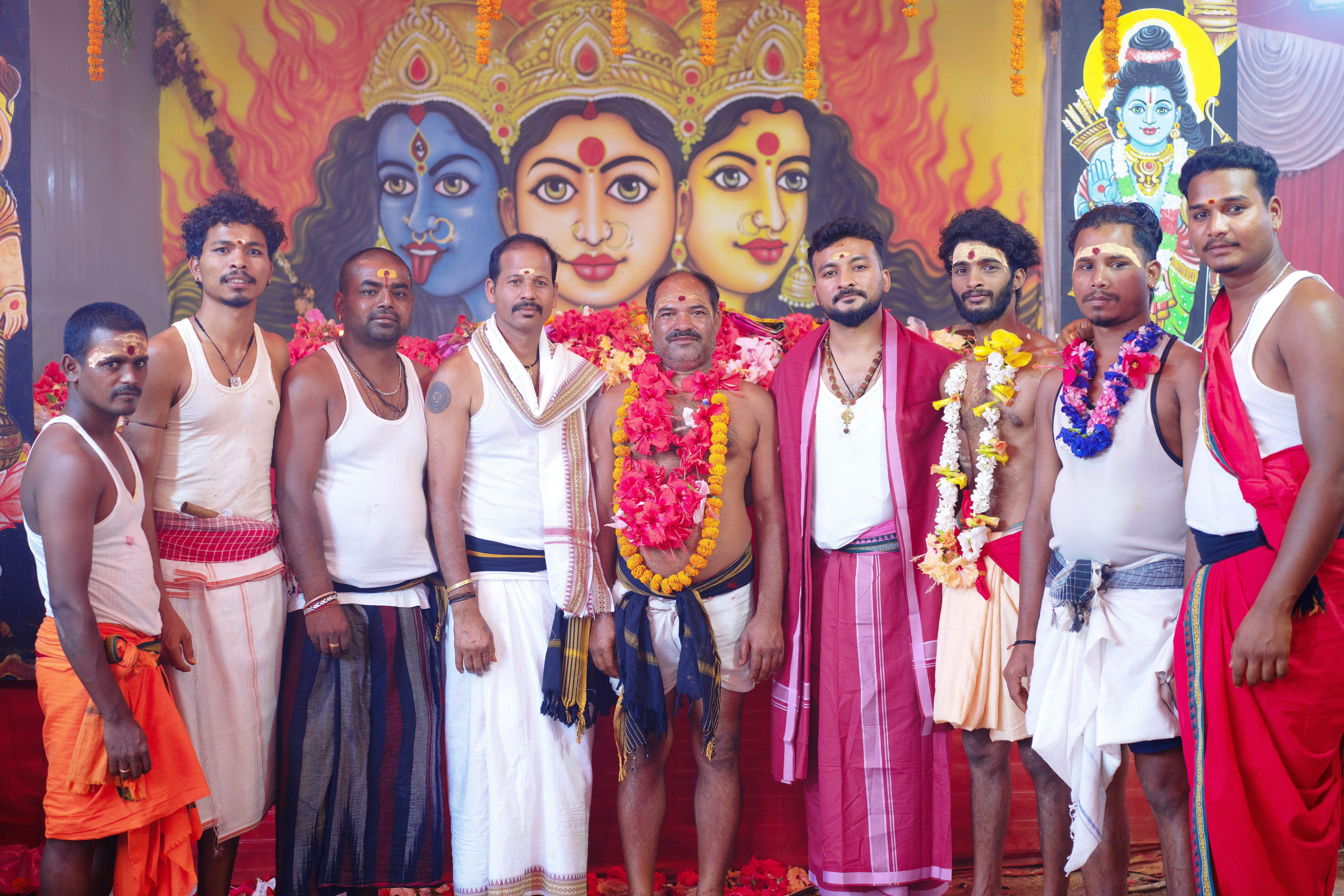 Group of men in traditional attire at a religious ceremony.