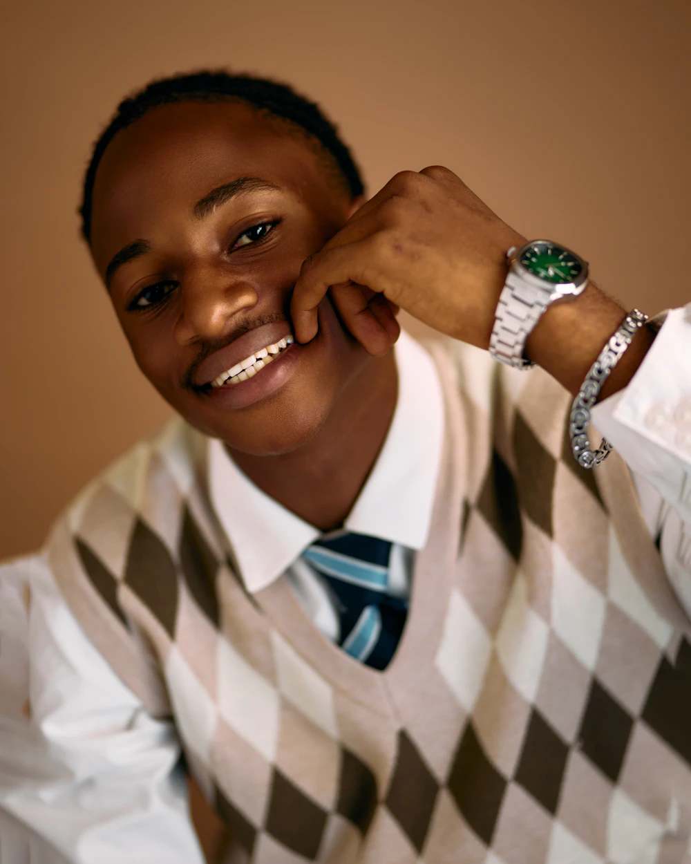 Tan argyle knit sweater vest over a shirt