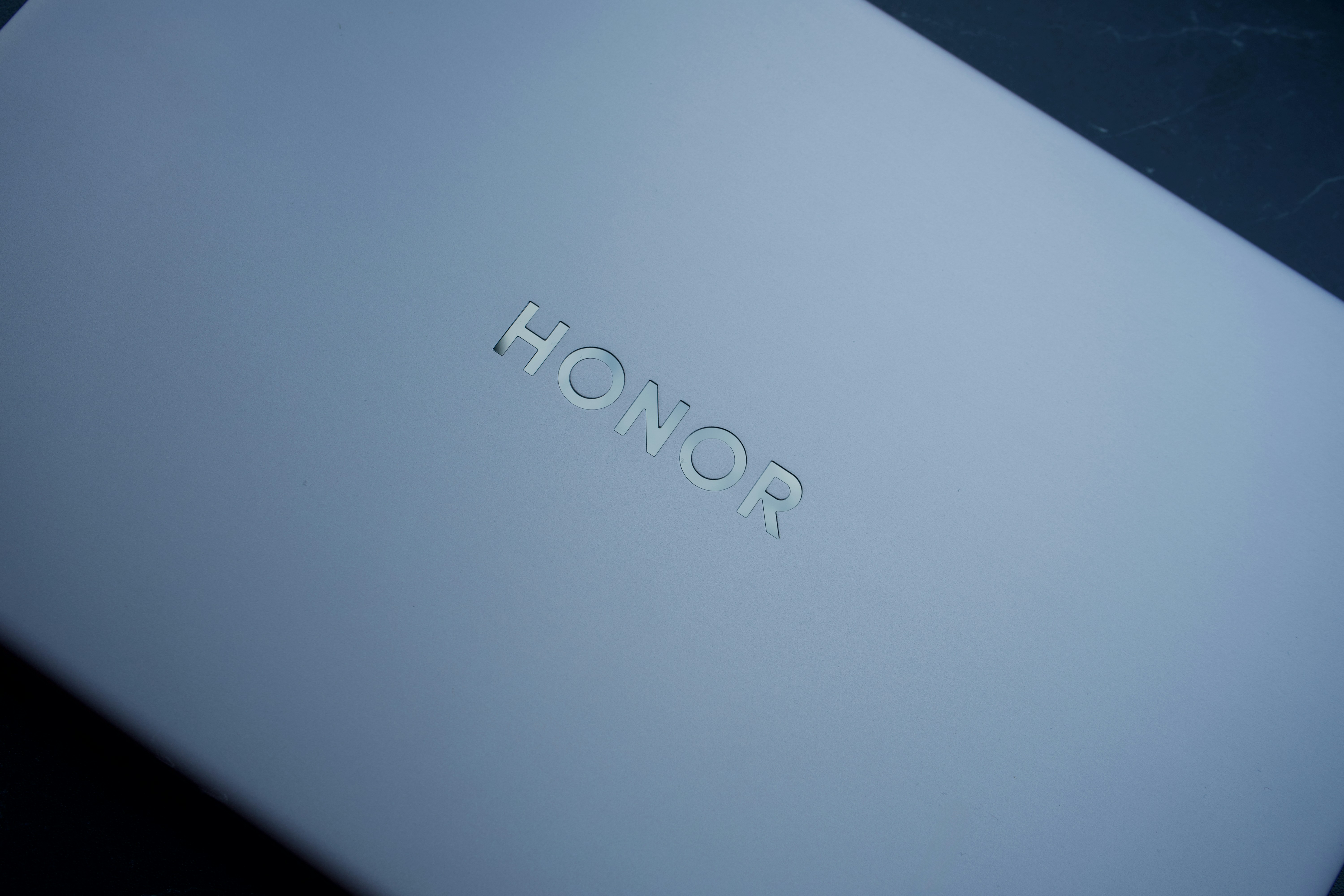 The word honor is embossed on a light gray surface.