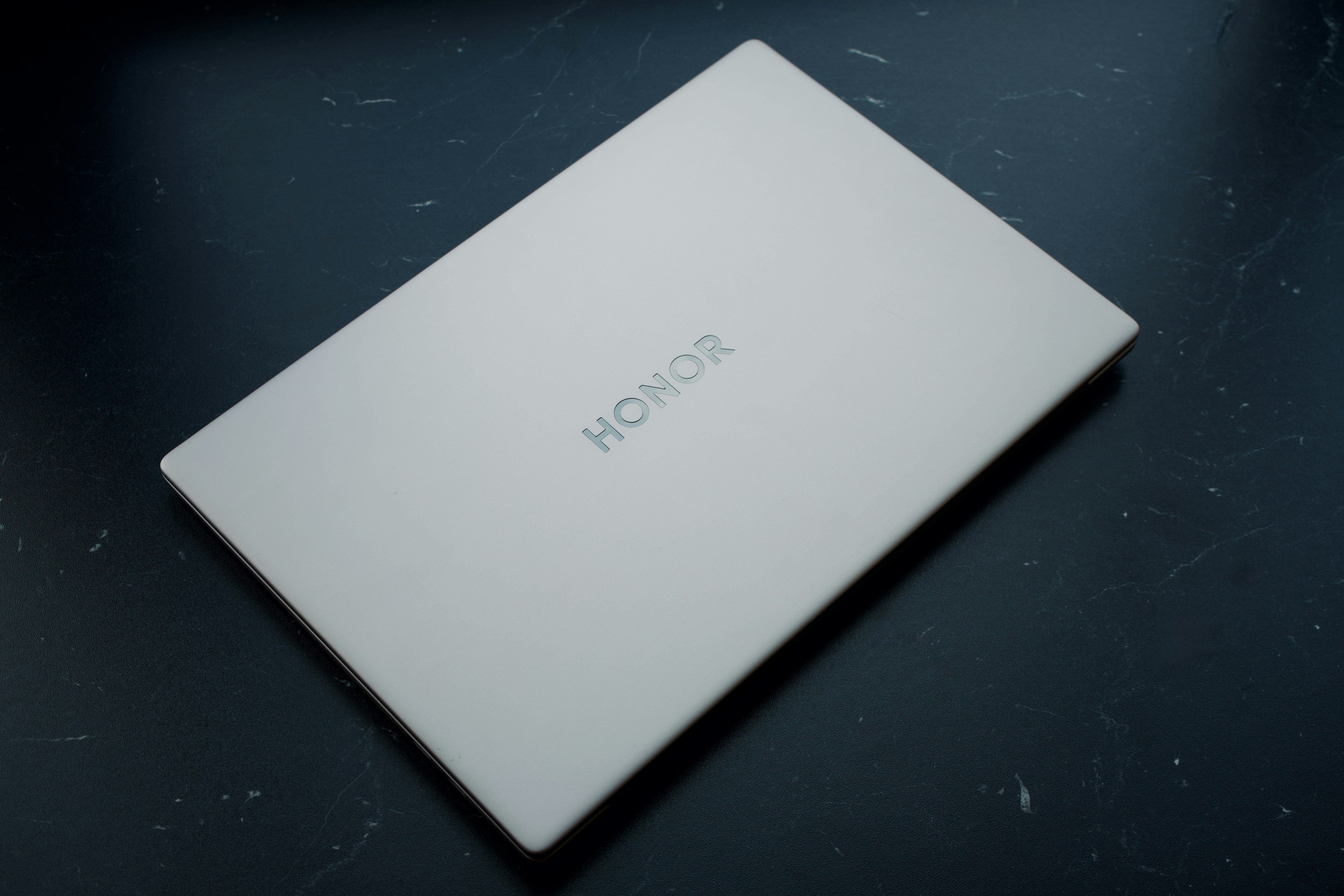 A white honor box on a dark surface.