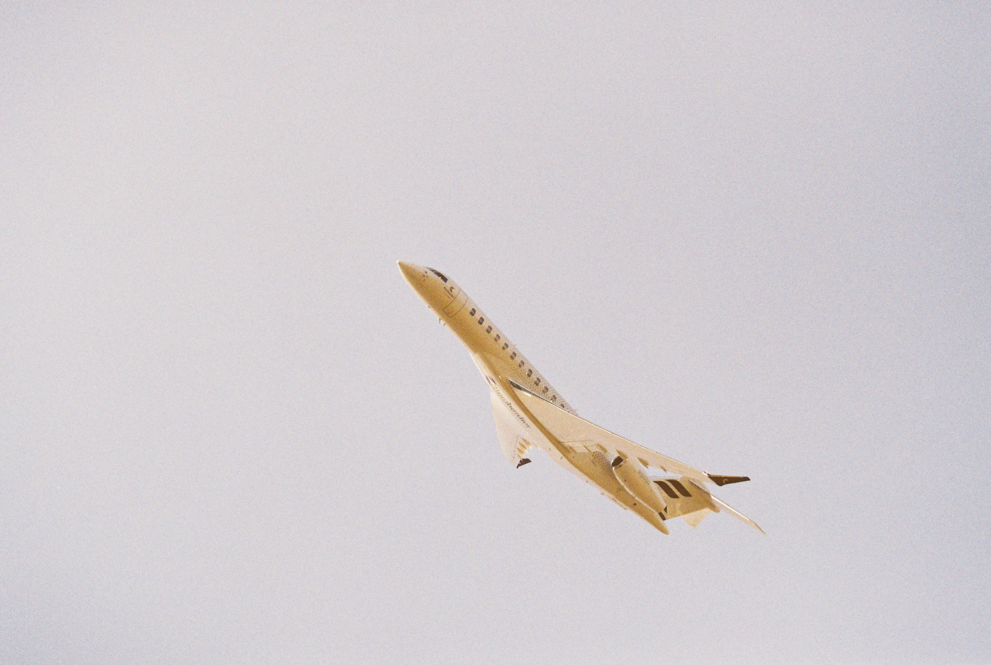 Concorde supersonic jet flying in a pale sky