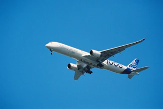 Airbus a350-1000 passenger jet flying against blue sky