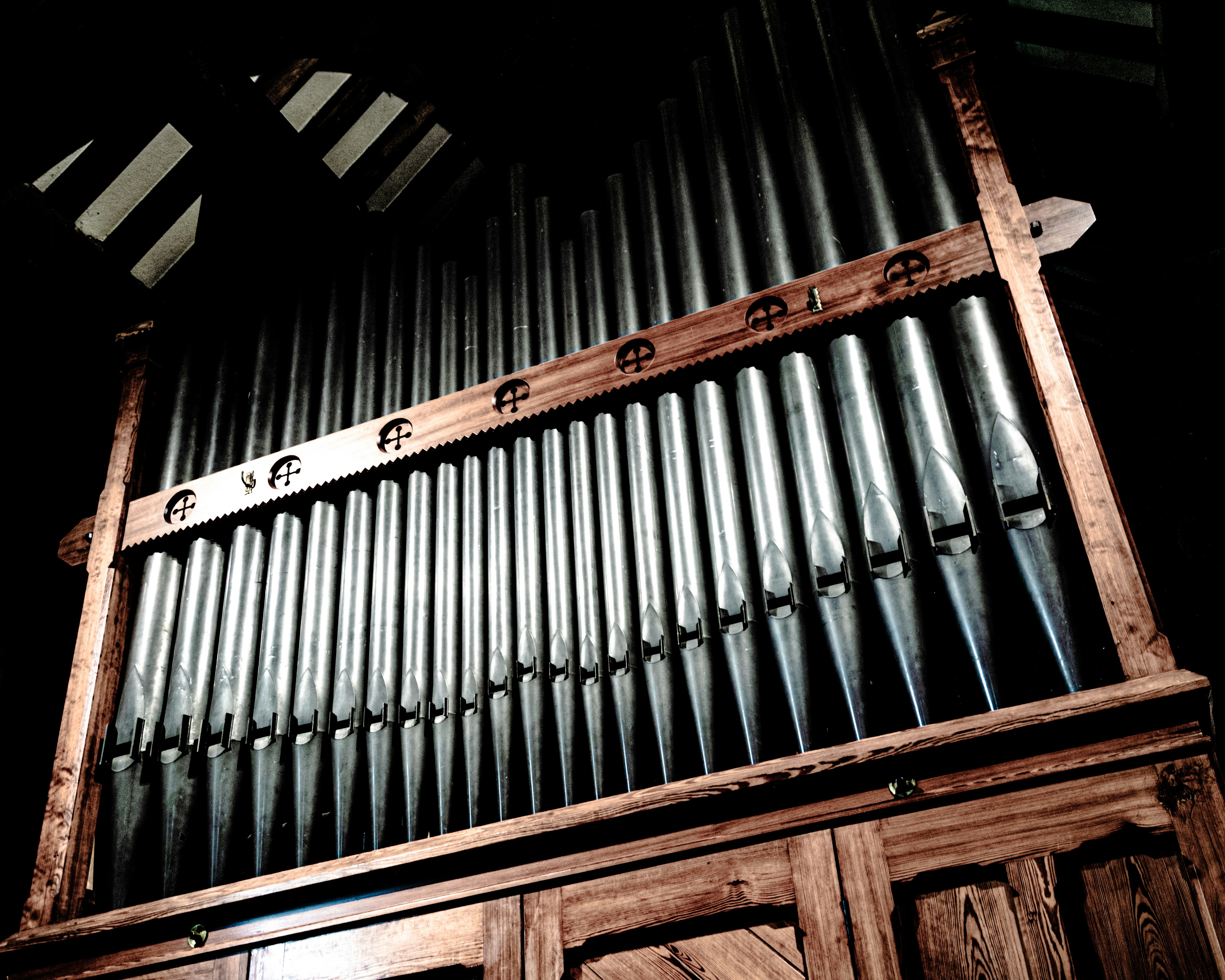 Ornate pipe organ with gleaming metal pipes and dark wood