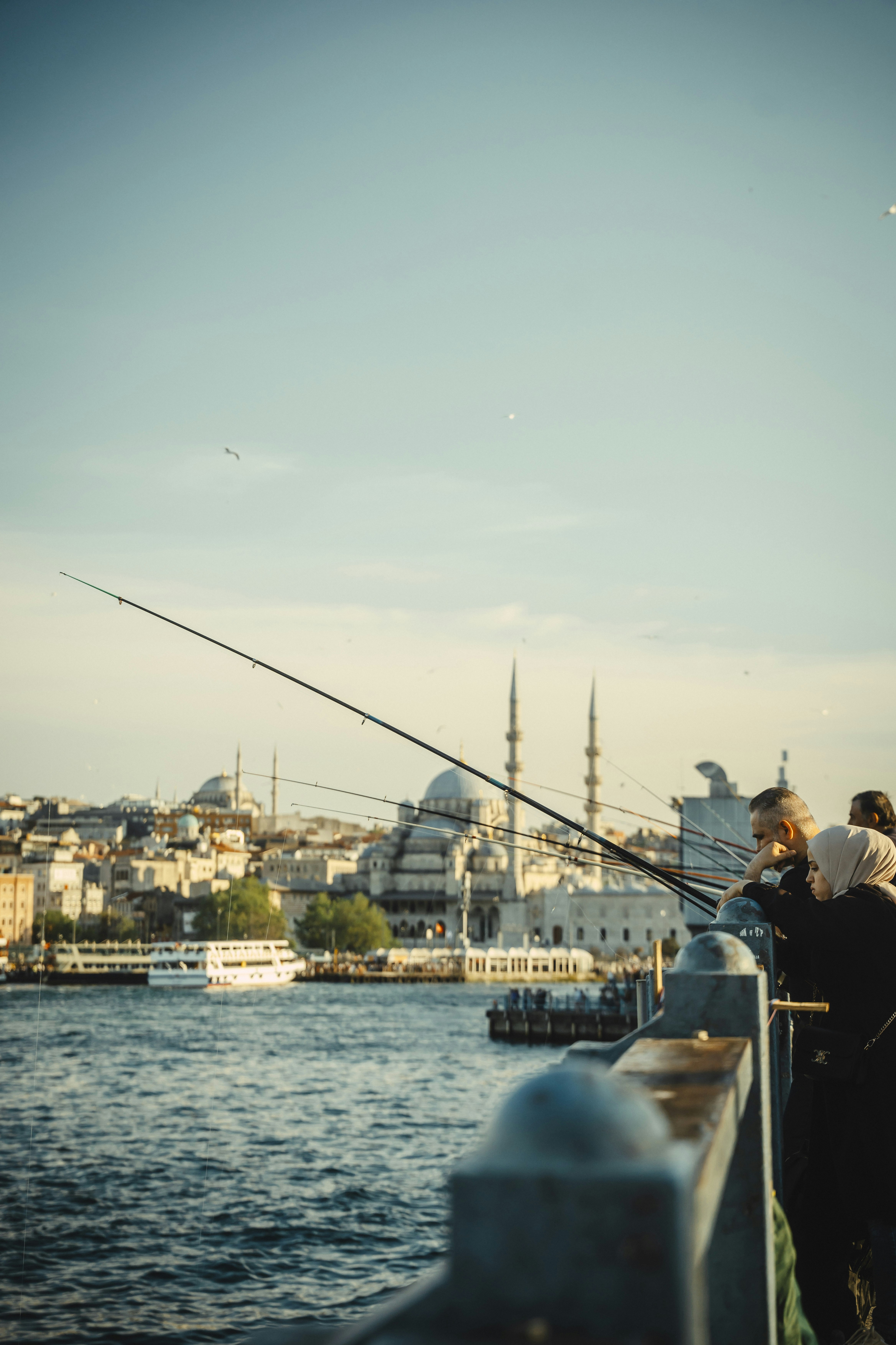 Pescatori sul ponte che domina lo skyline di Istanbul con moschee