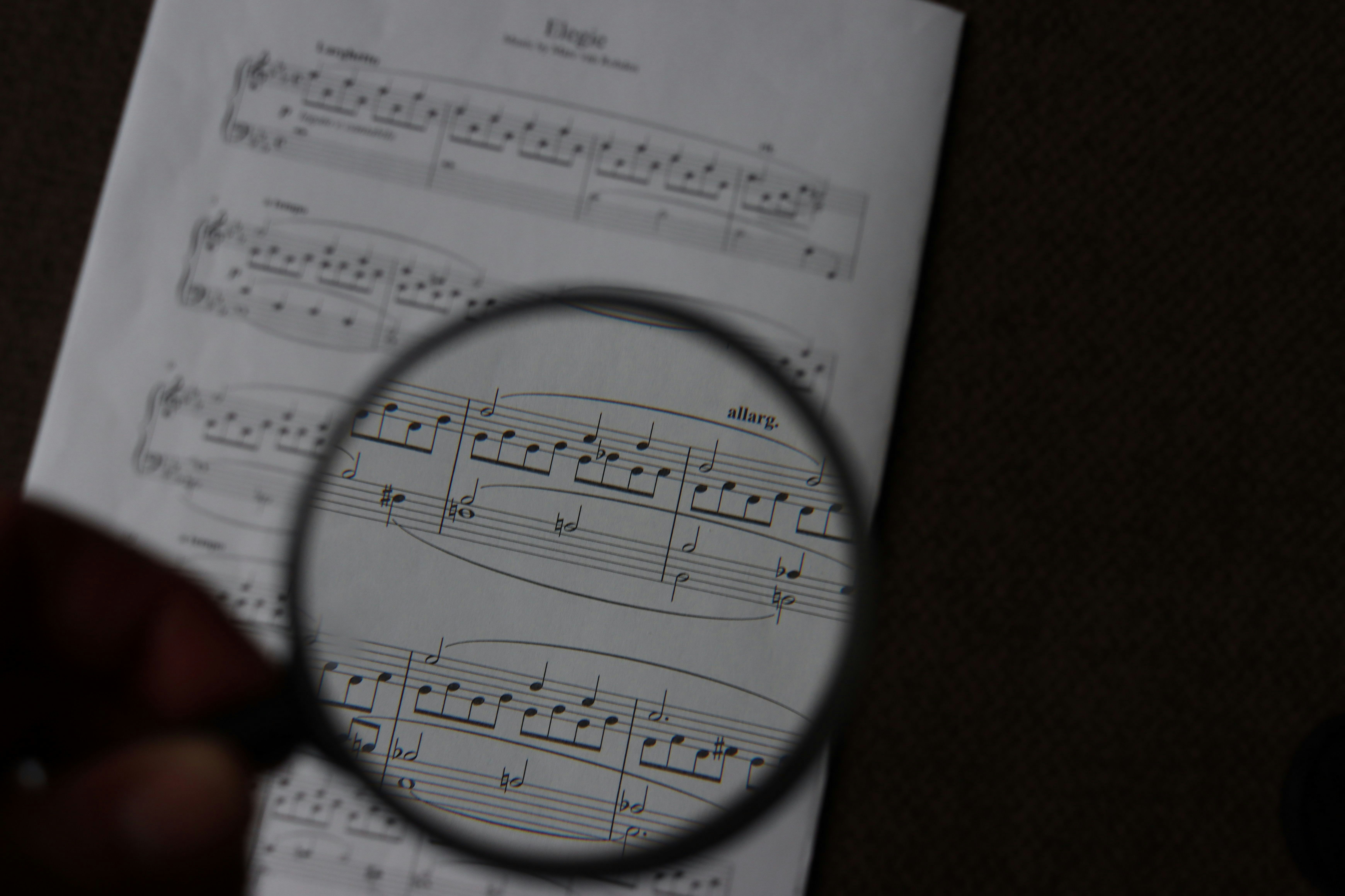 A magnifying glass held over sheet music
