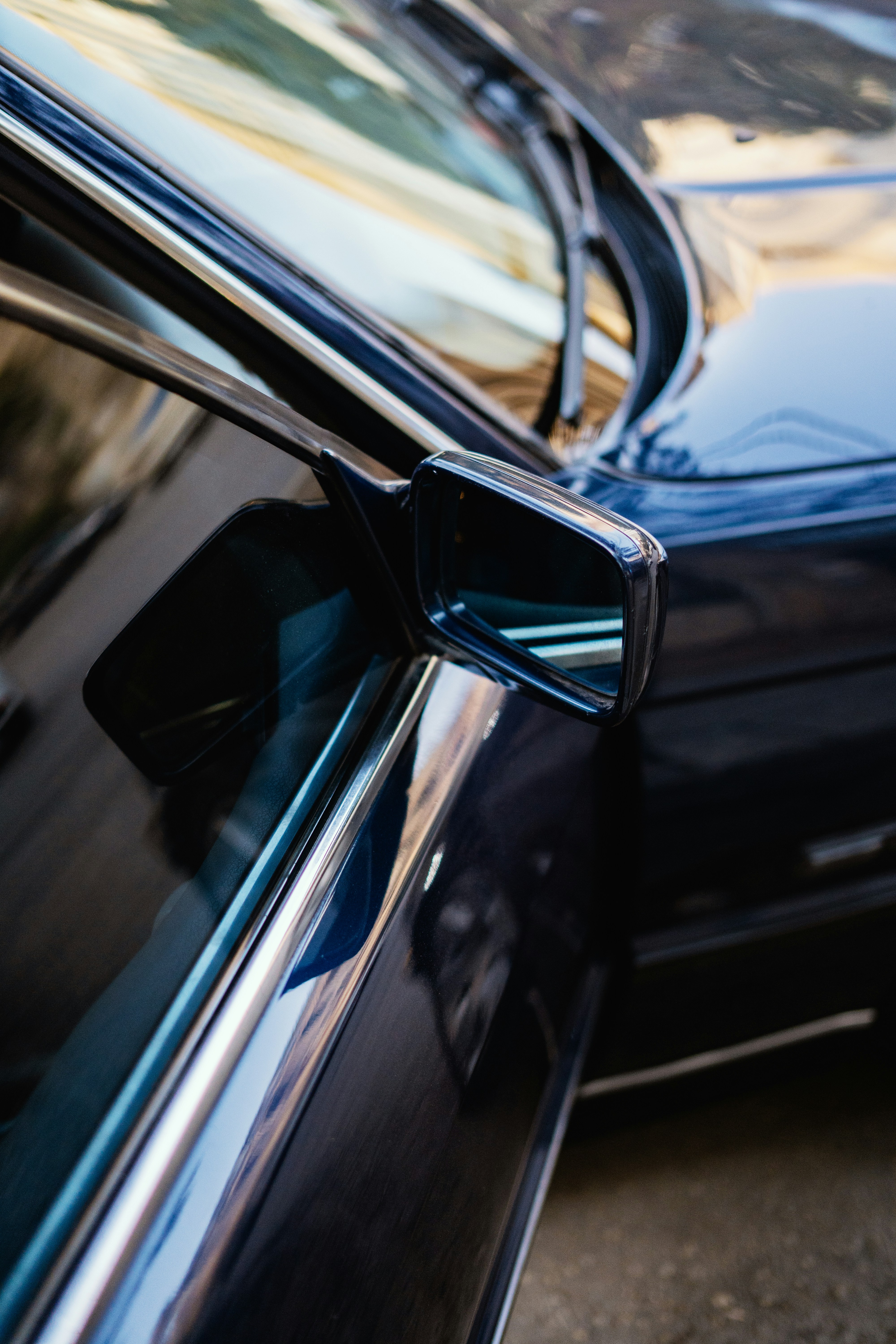 Reflective dark blue car side and rearview mirror