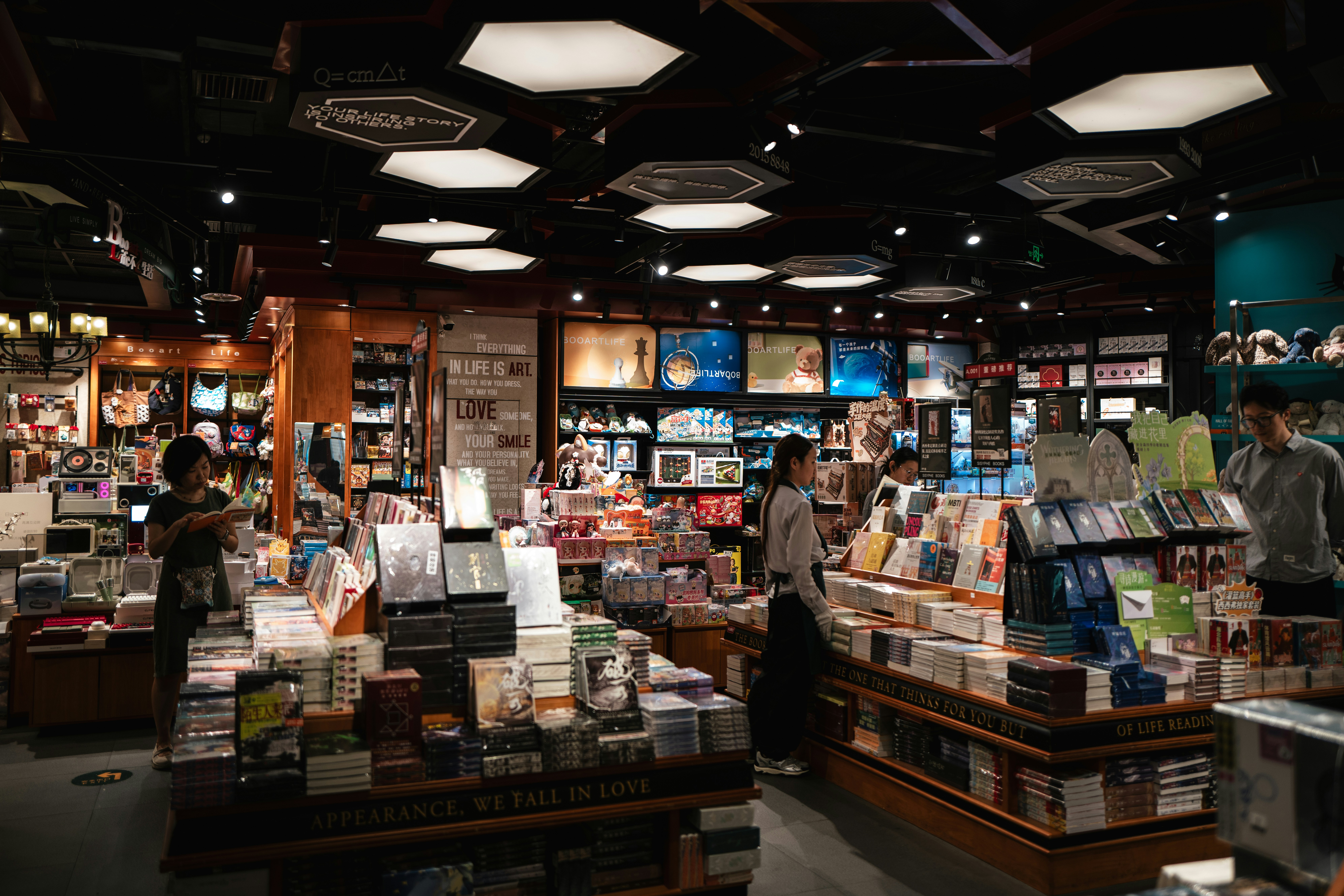 People browsing books and products in a bustling bookstore