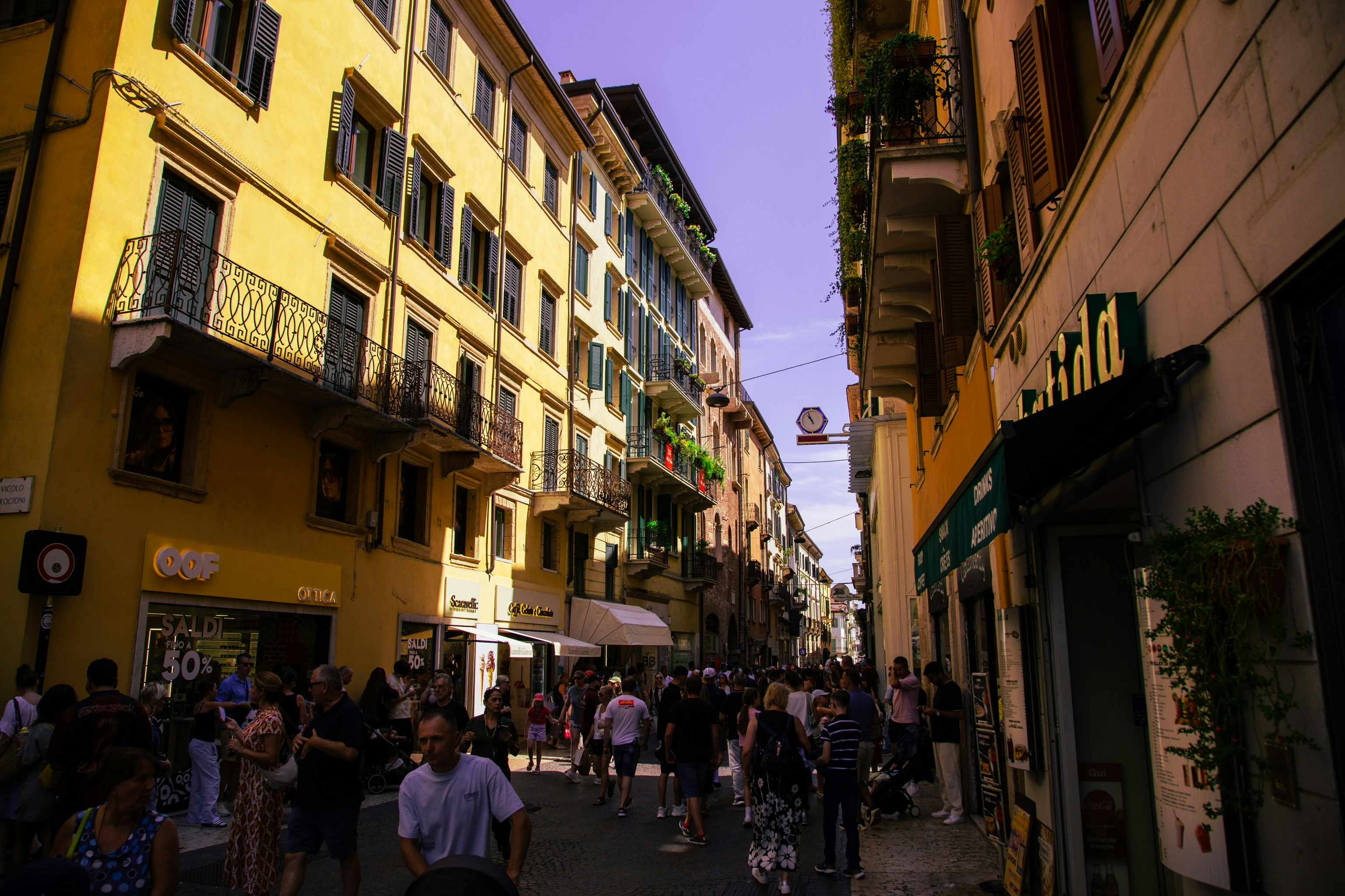 Crowded european street with colorful buildings and pedestrians