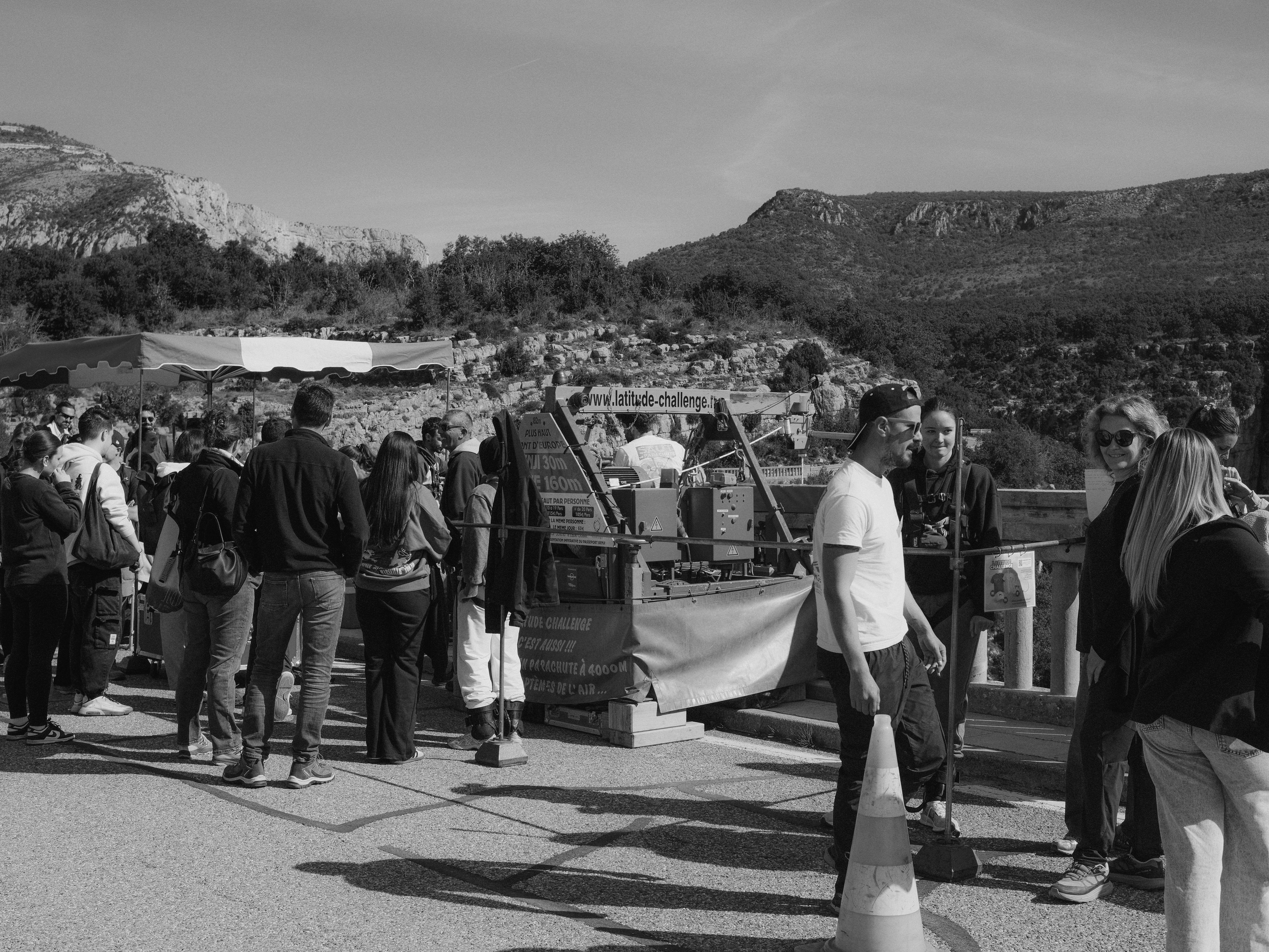 People gathered outdoors with mountains in the background