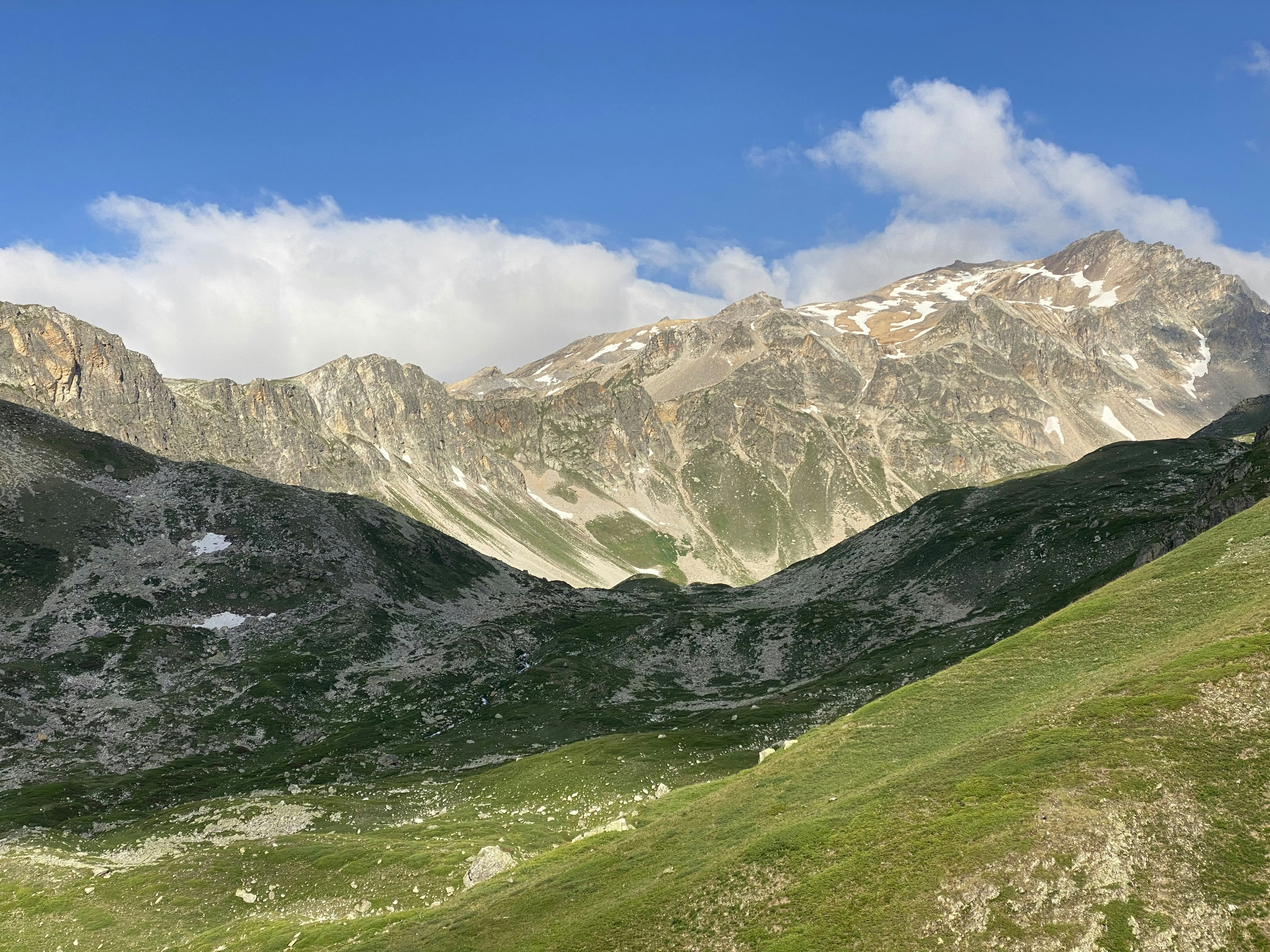 Majestic mountains with green valleys under a blue sky