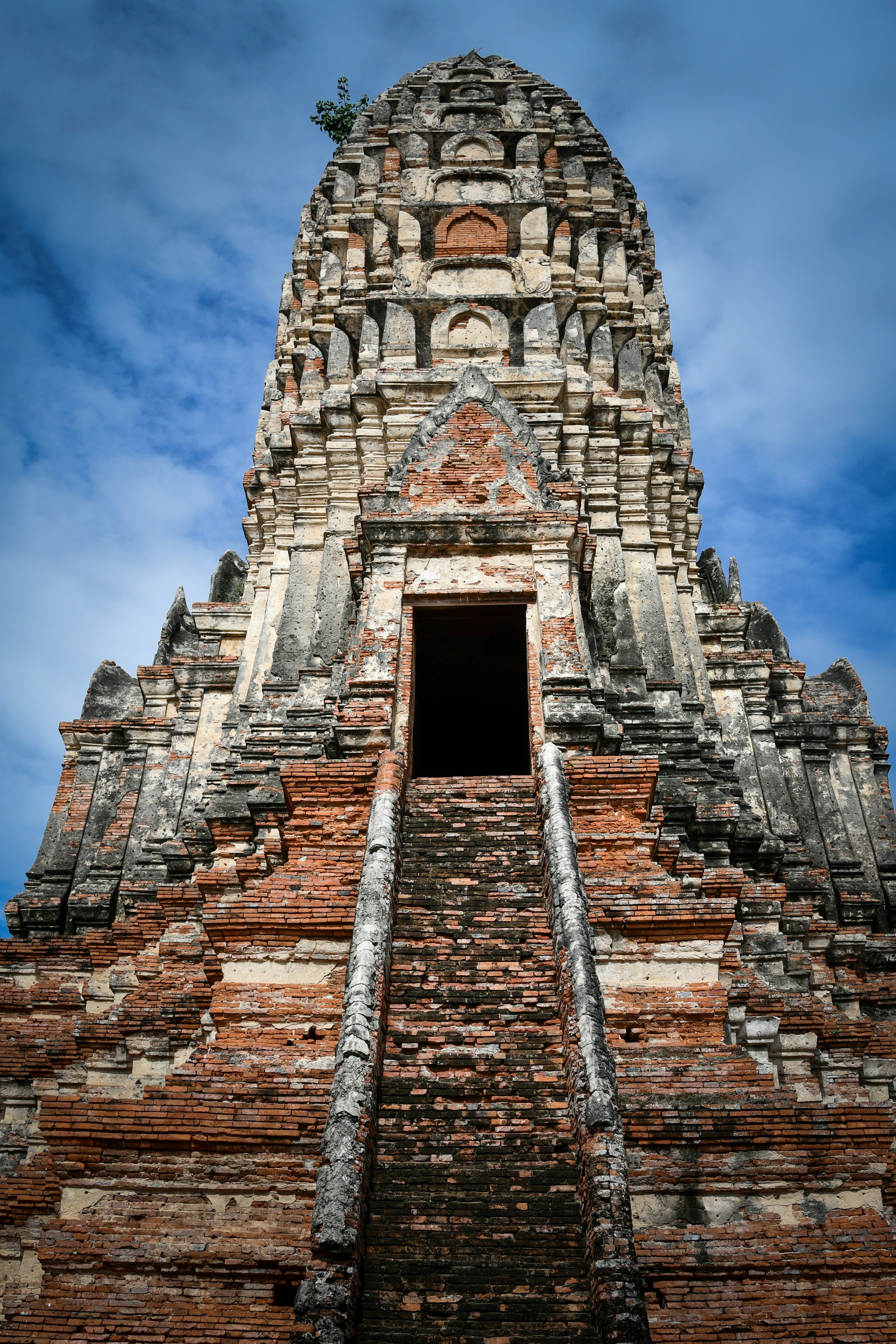 Weathered ancient temple spire with a long stairway.