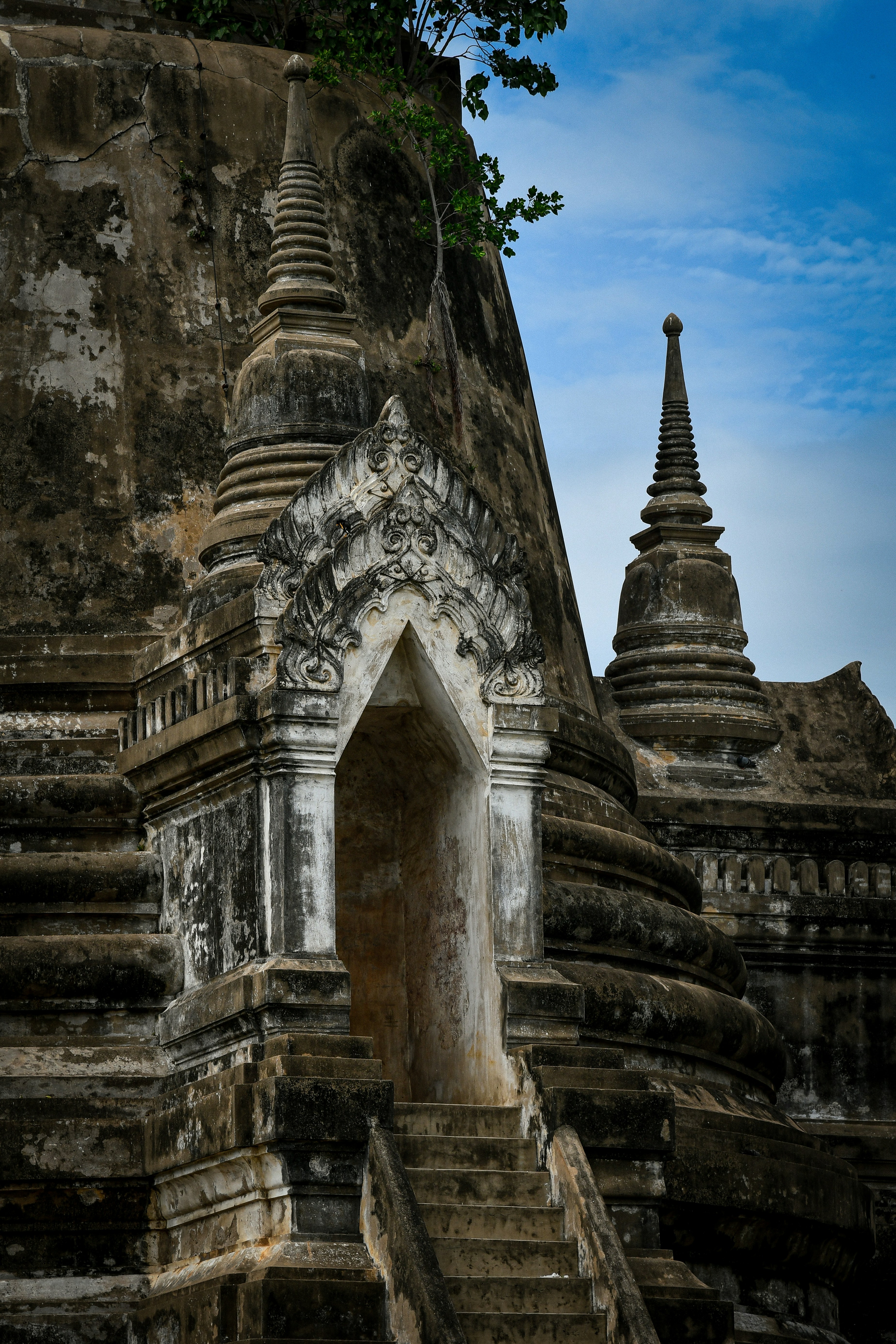 Ancient stone temple structures with spires and an arched entrance.