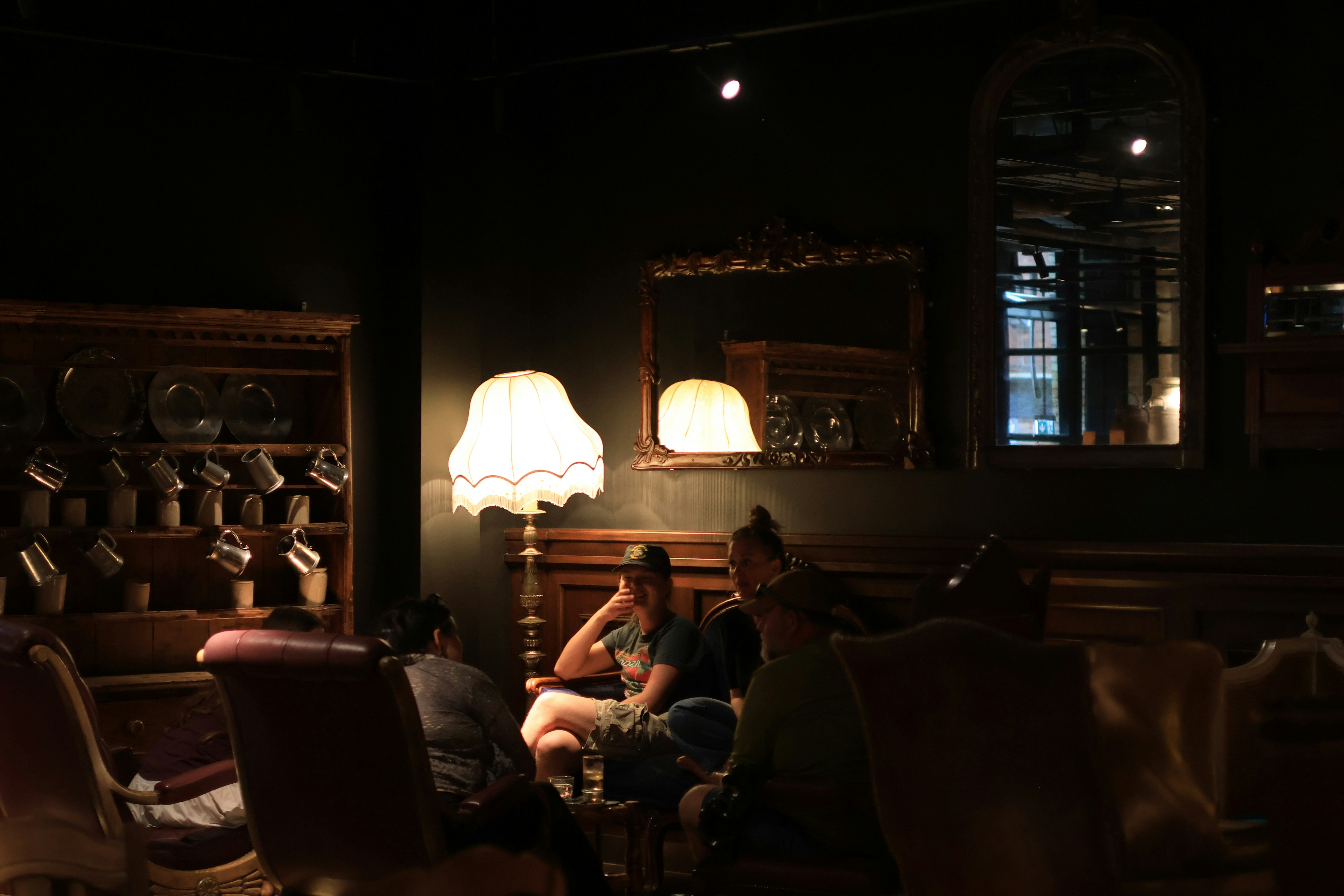PLACEHOLDER — replace with the room at night: warm lamps, brick, people in the booths.