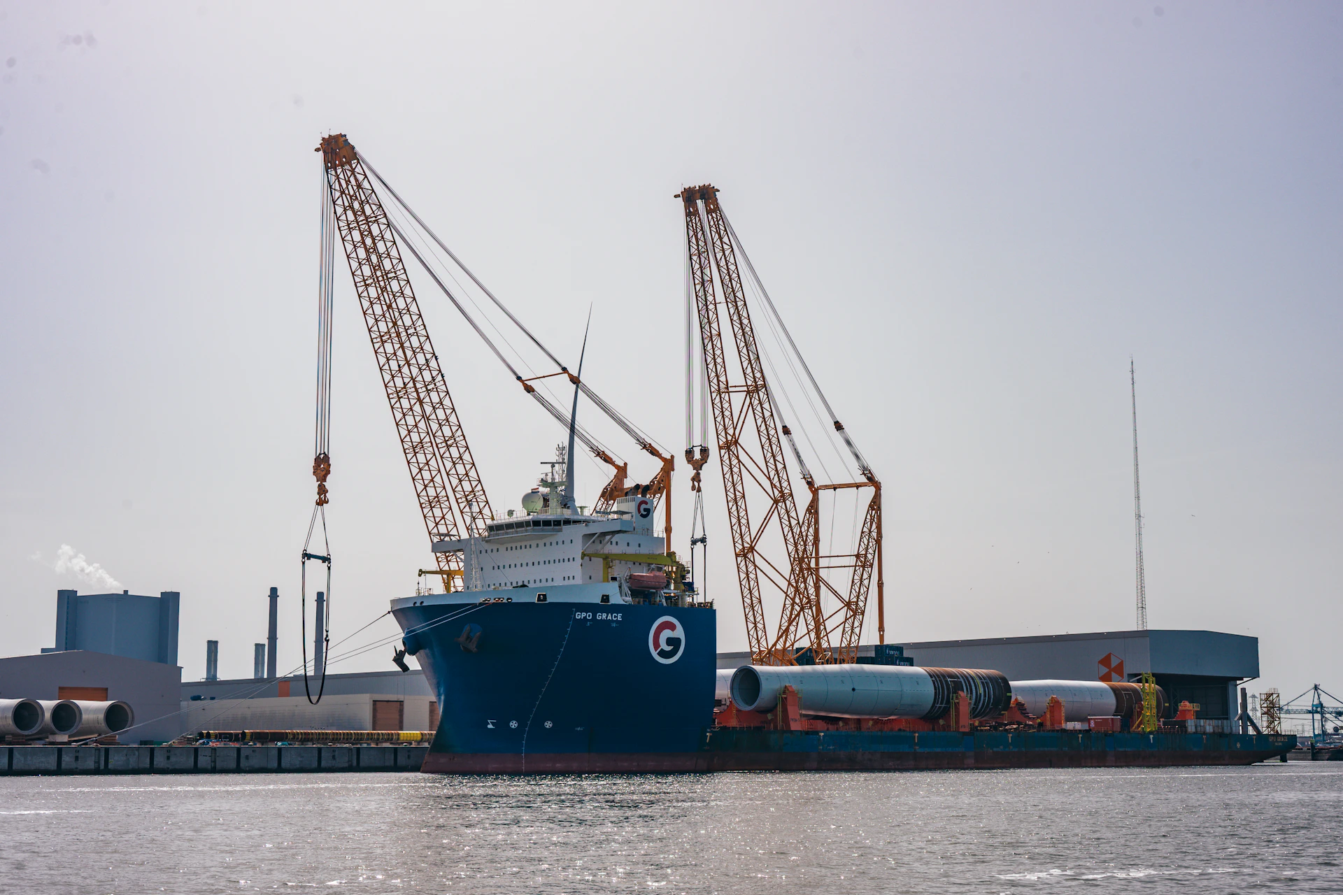 Ship loading wind turbine parts at an industrial port
