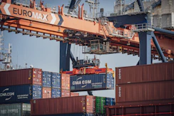 A large euromax crane lifts a cma cgm shipping container