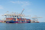A large container ship docked at a busy port