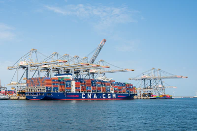 A large container ship docked at a busy port