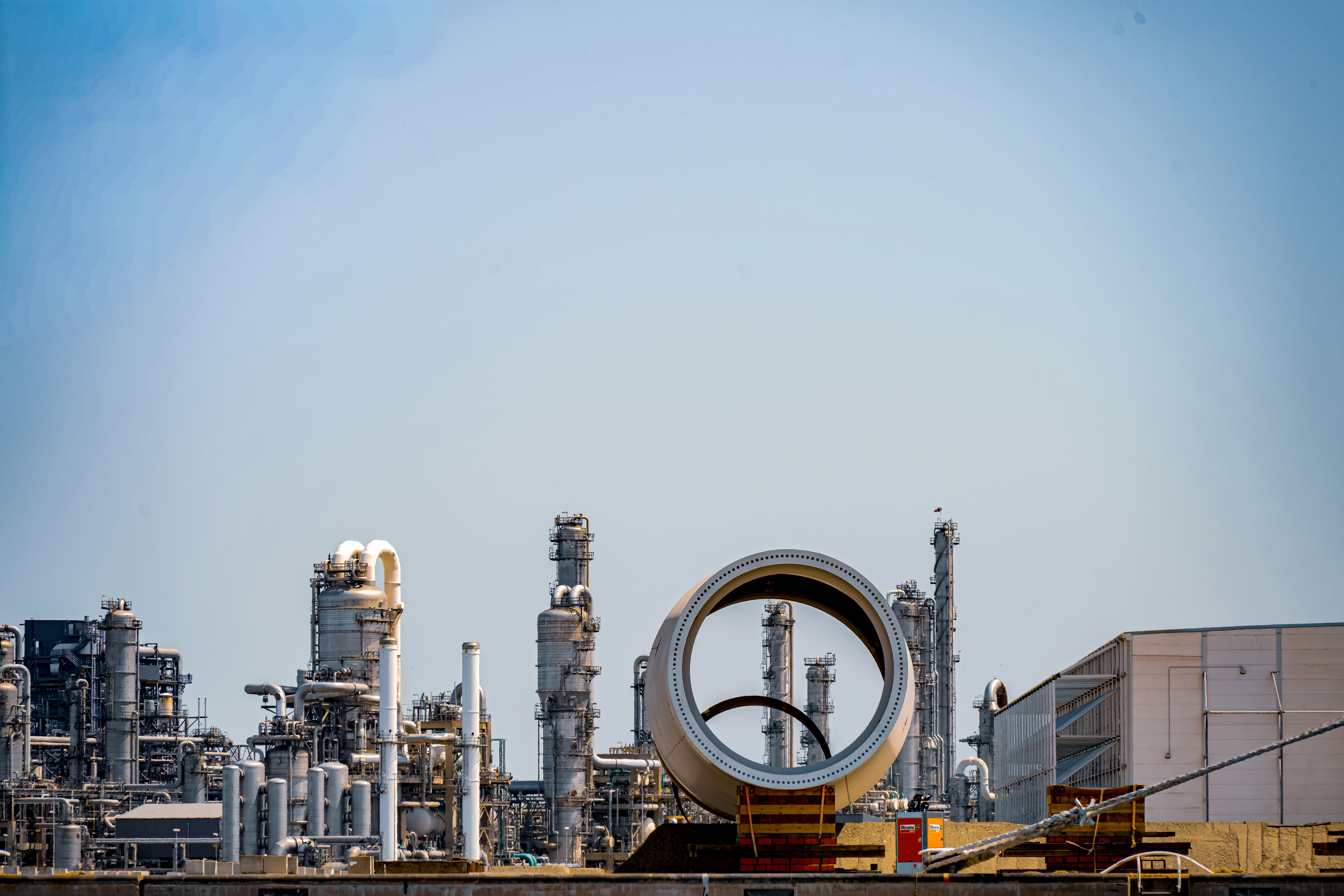 Industrial refinery with a large circular structure in foreground