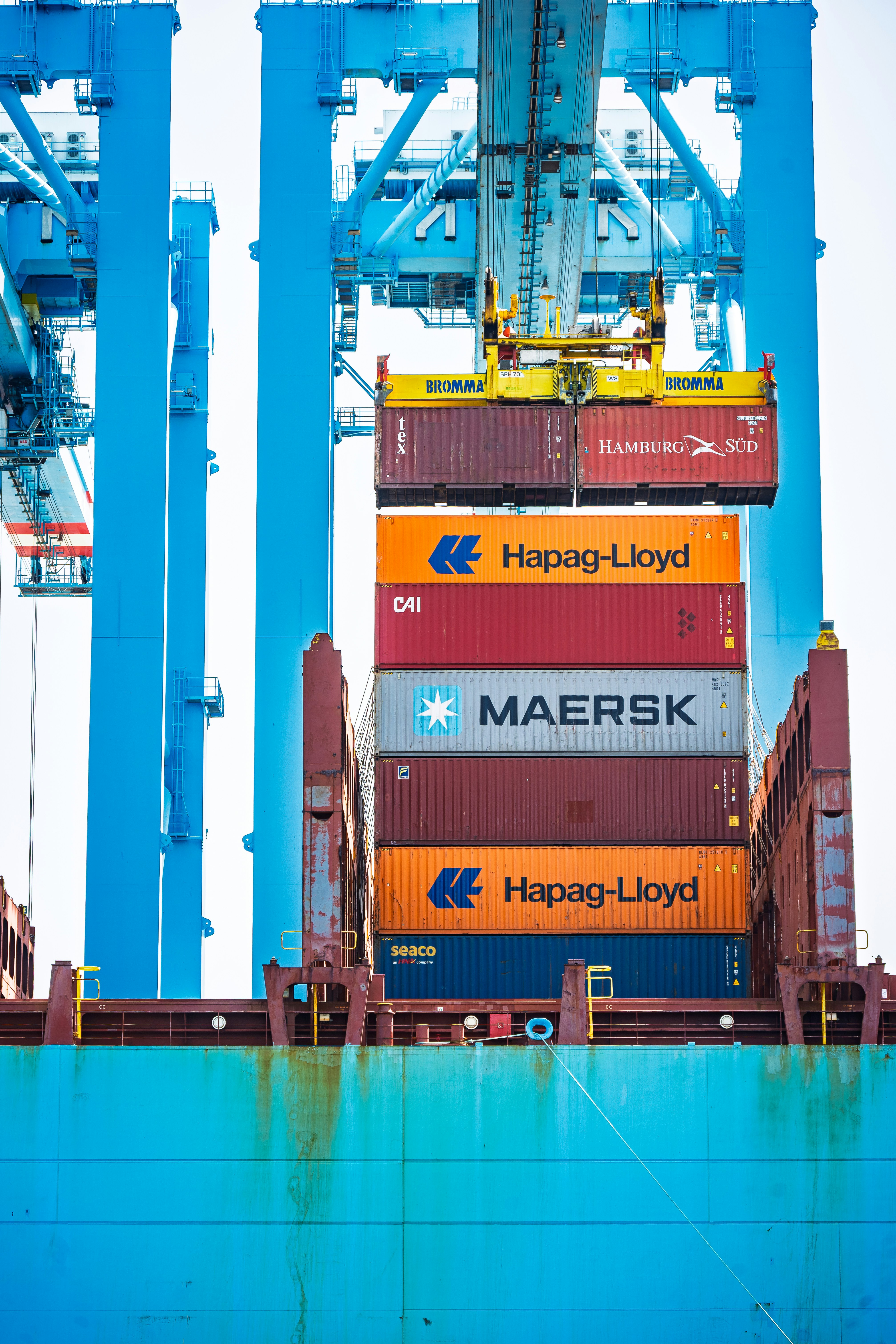 Crane loading containers onto a cargo ship at dusk