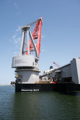 Large pioneering spirit vessel with a massive red crane.